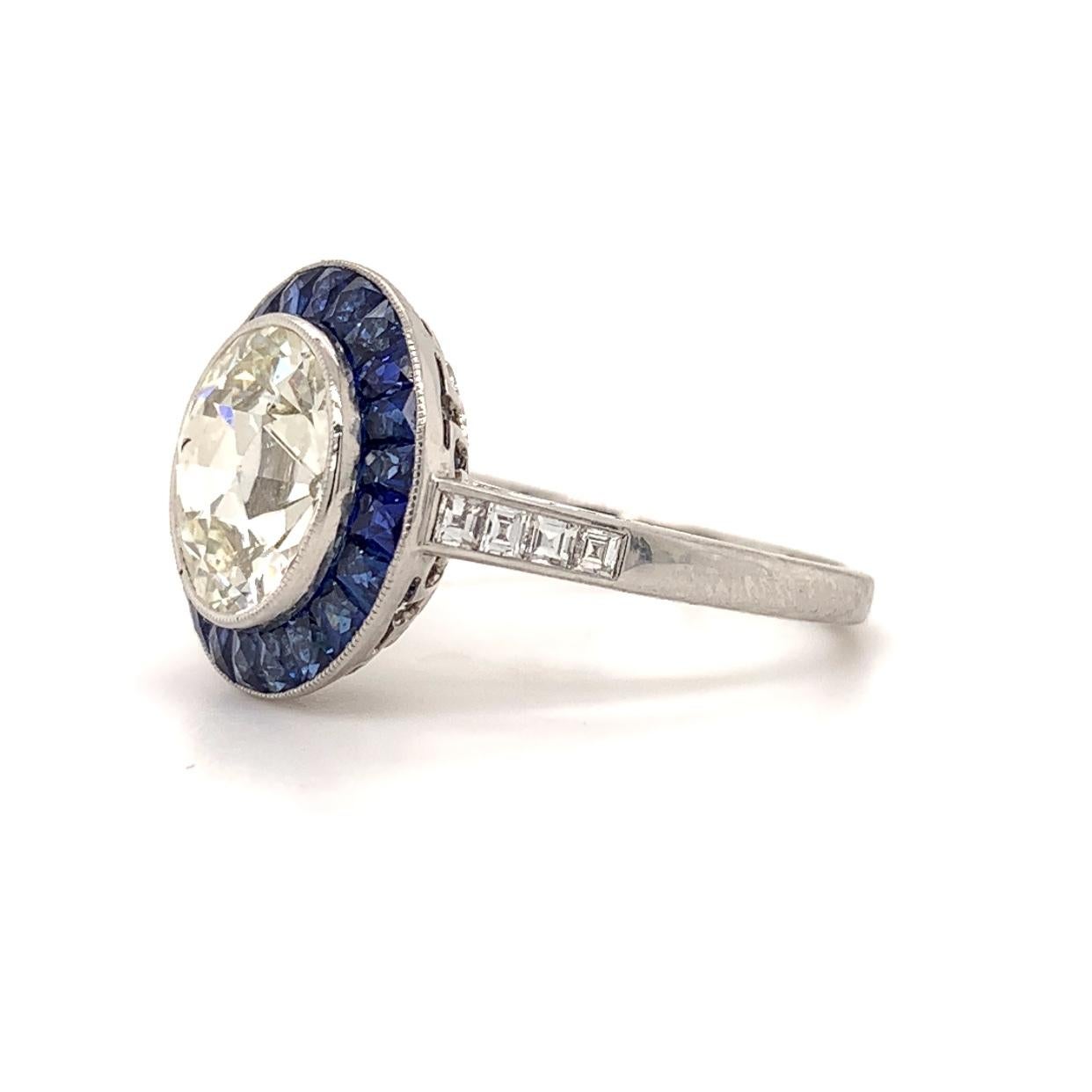 Sophia D. Elegant platinum Old European 3.04 carat center round diamond with a color and clarity of M-VS2 surrounded with blue sapphires weighing 0.90 carats and diamonds weighing 0.20 carat ring.

Sophia D by Joseph Dardashti LTD has been known