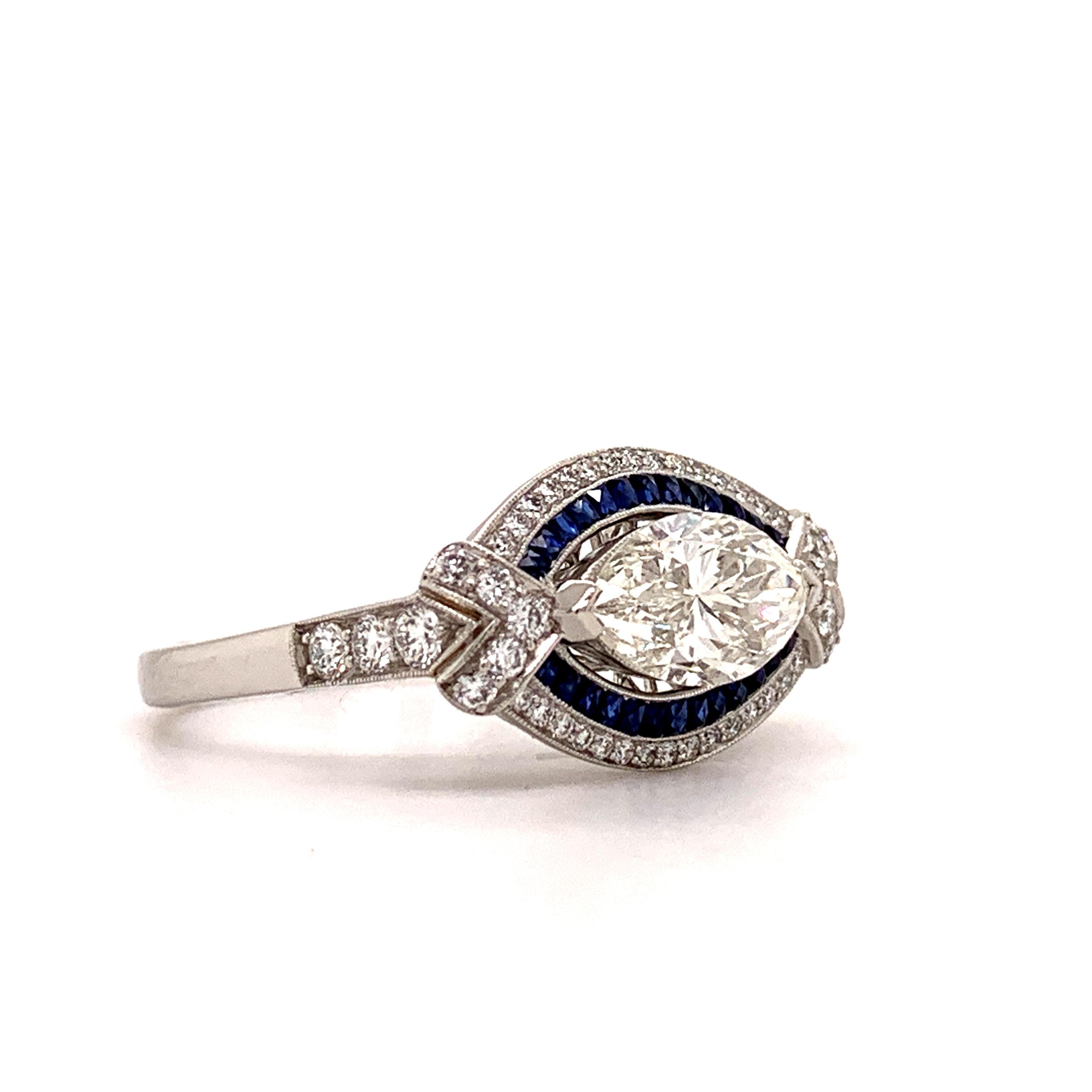 Sophia D Art Deco inspired platinum ring with pear shape center marquise diamond weighing 1.31 carats with a color and clarity of I-VS2 surrounded with beautiful sapphire stones weighing 0.25 carats and diamond weighing 0.35 carats.

Sophia D by