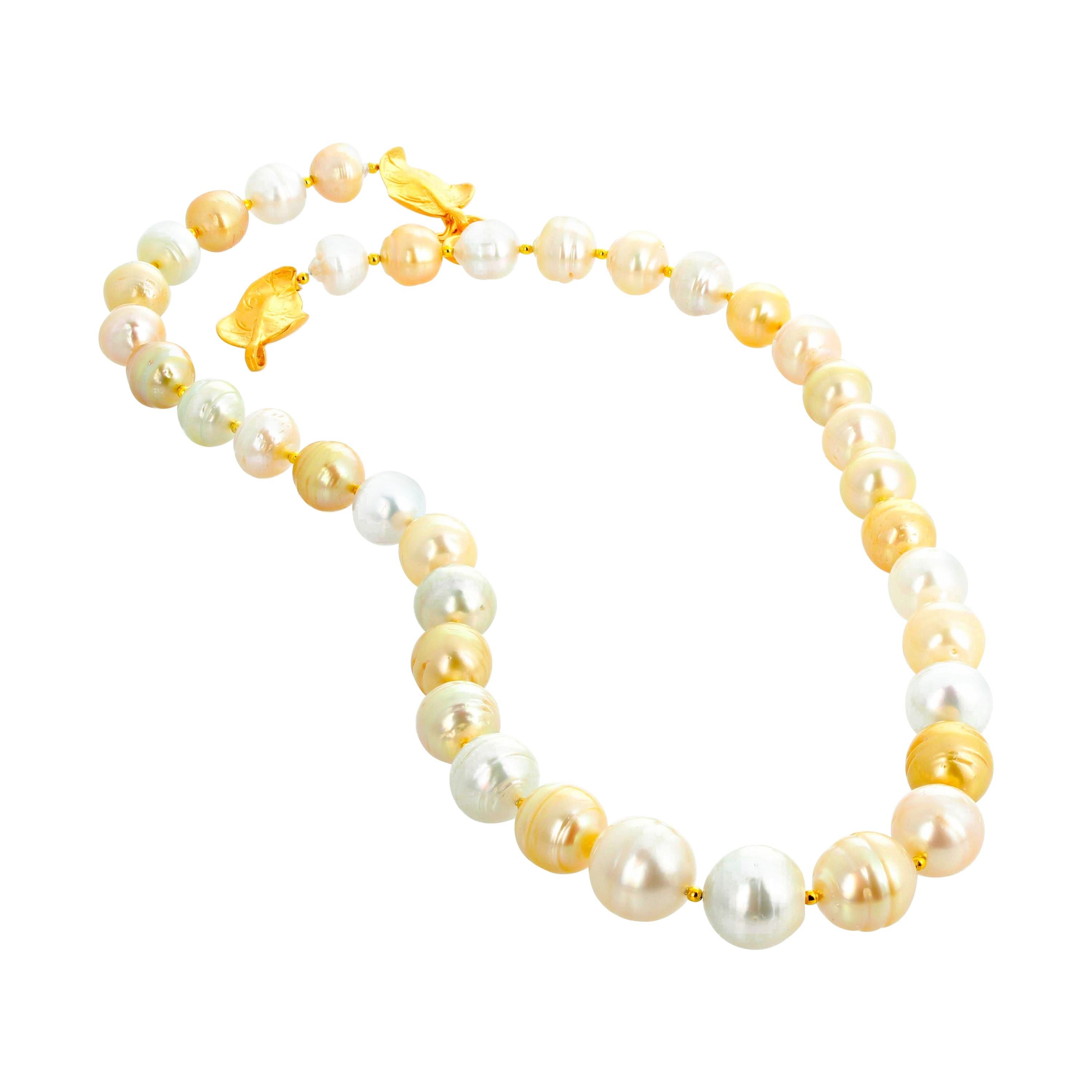 Beautiful South Sea Fresh Water Goldy and White and Creamy natural Cultured Pearls with Vermeil (gold plated silver) easy to us hook clasp.  The pearls are graduated in size with the largest pearl 14 mm and the smallest 10 mm and it is 23 inches