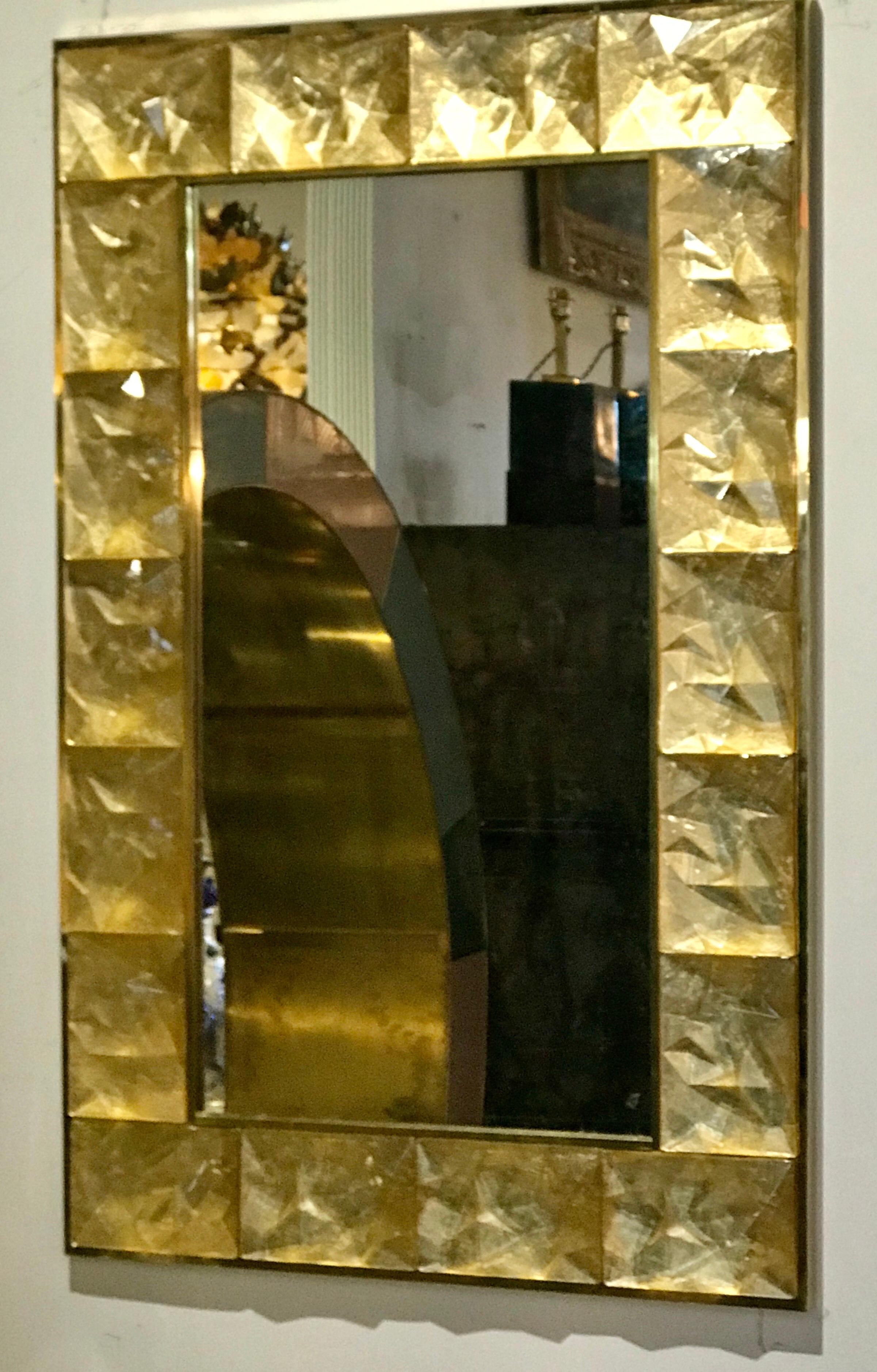 Beautiful multi-faceted artisanal vintage gold Murano glass fitted to a thick brass frame creating a mirror of glass art, Italy.

  