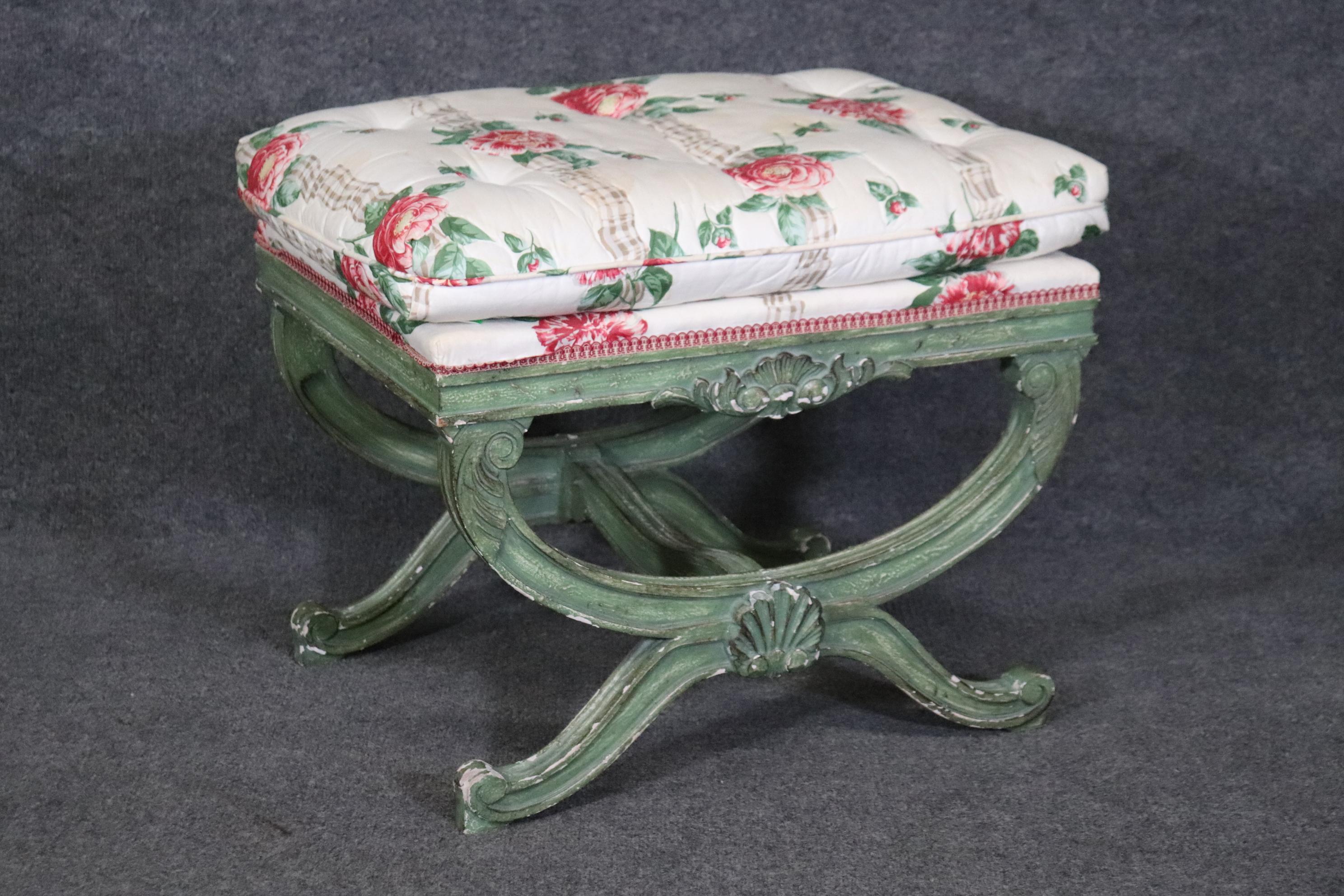 This is a gorgeous Regency style bench. The 1950s era bench features a time-worn chippy green painted frame with some fancy floral upholstery. The upholstery as with the frame will show signs of age and use and stains on the upholstery. Measures