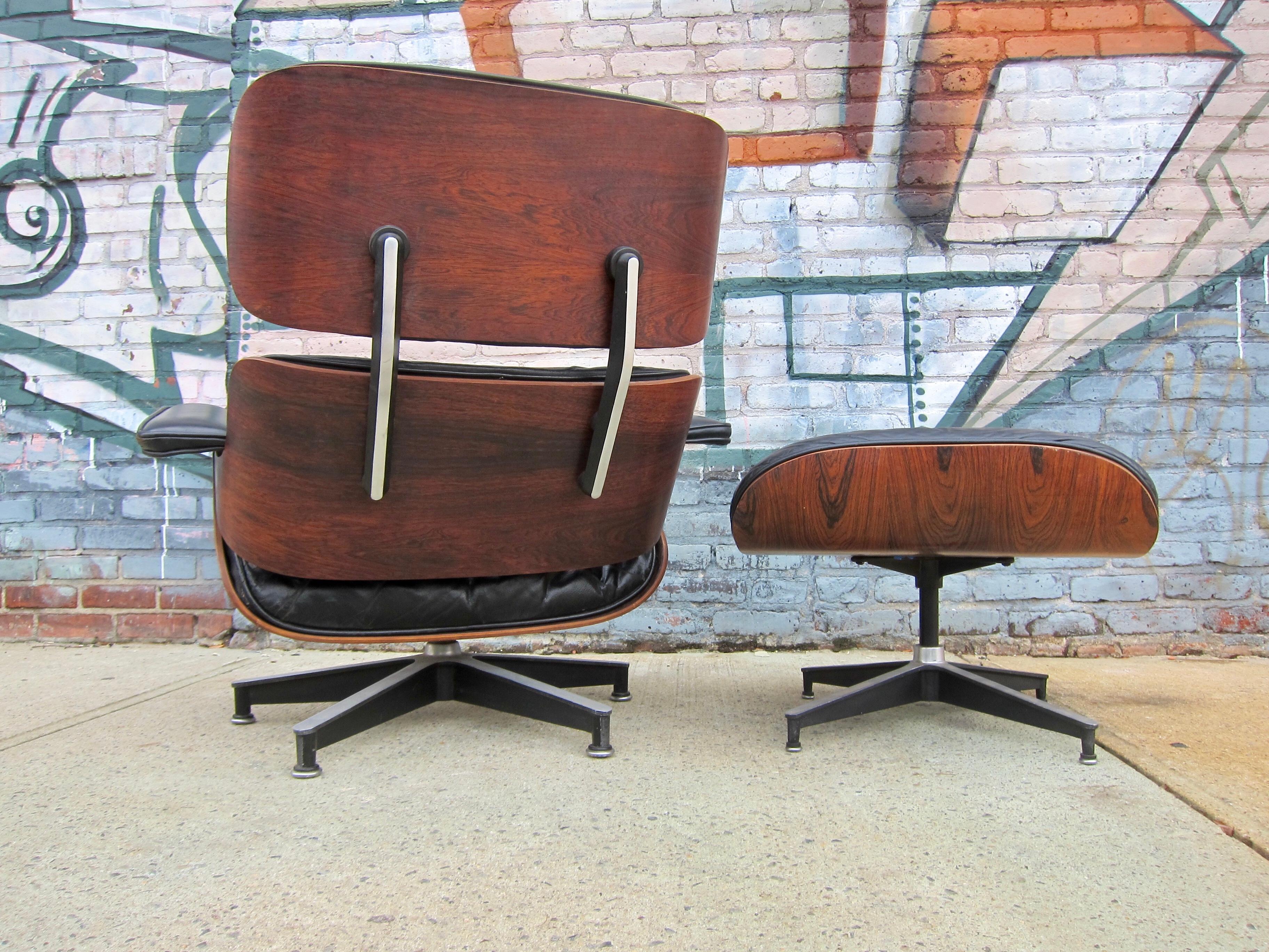 Gorgeous George Nelson lounge chair and ottoman, circa early 1960s. Signed with manufacturer tag and patent label. Original down cushions. Lovely wood grain and black tones. New mounts installed at $500 value. Ready for immediate use.