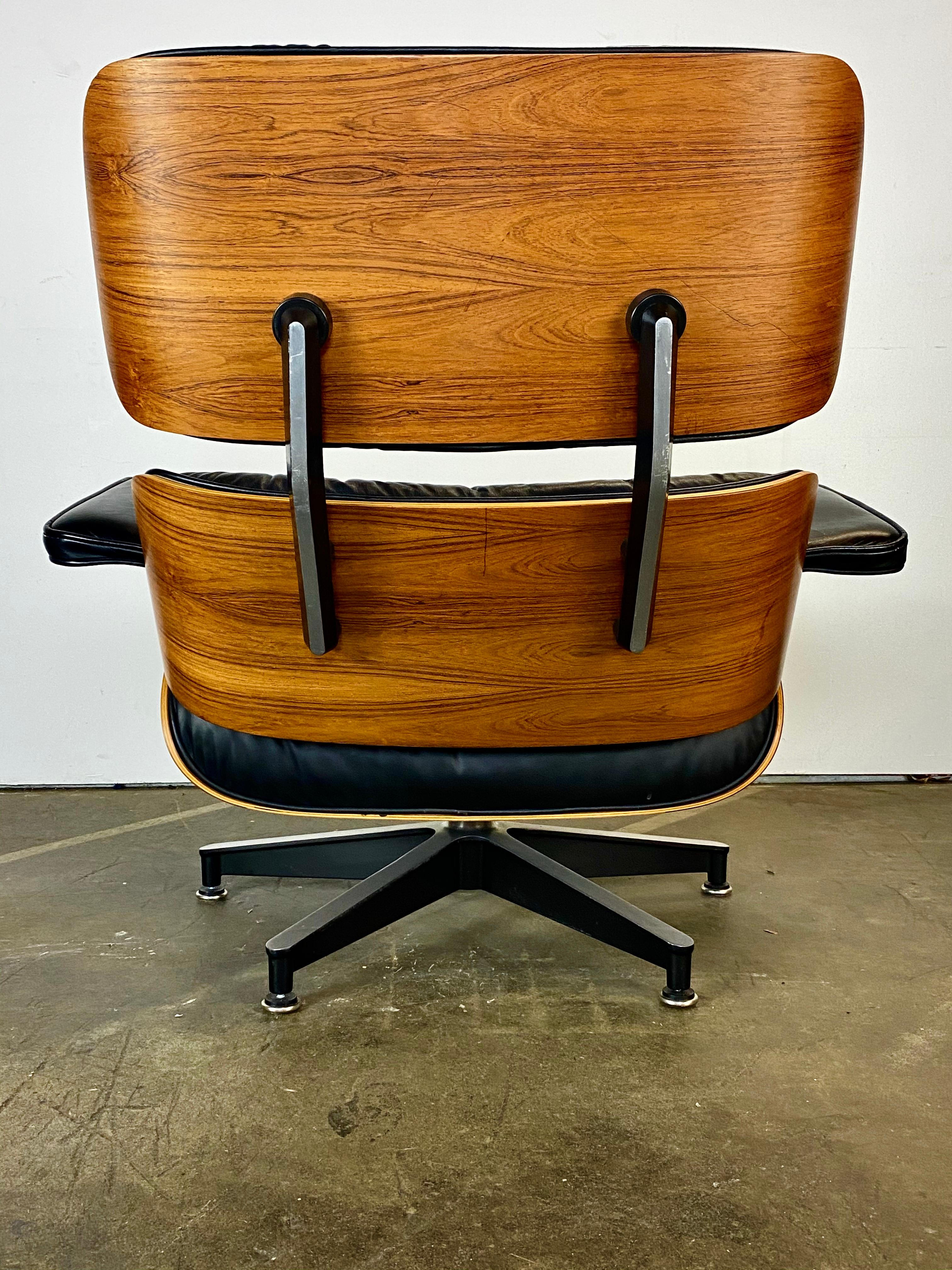 Classic Eames lounge chair and ottoman. Executed in black leather and rosewood shells. Signed on chair and guaranteed authentic. No missing buttons or screws. Glides on chair and ottoman are adjustable in case the floor or carpet is uneven. Gorgeous