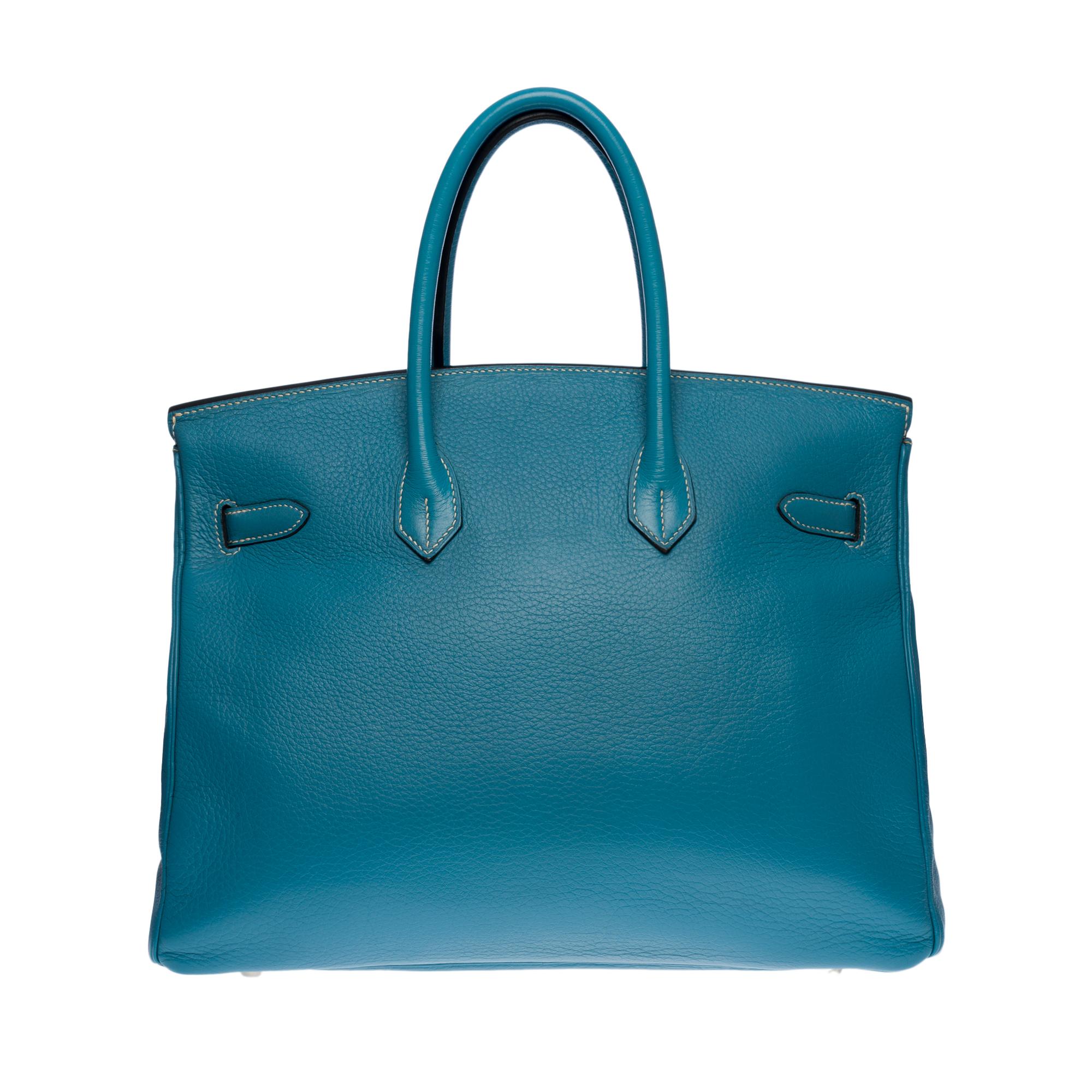 Amazing Hermes Birkin 35 handbag in Togo Blue Jeans Togo leather with white stitching, Palladium silver metal hardware, double blue leather handle for a hand carry

Flap closure
Inner lining in blue leather, one zippered pocket, one patch