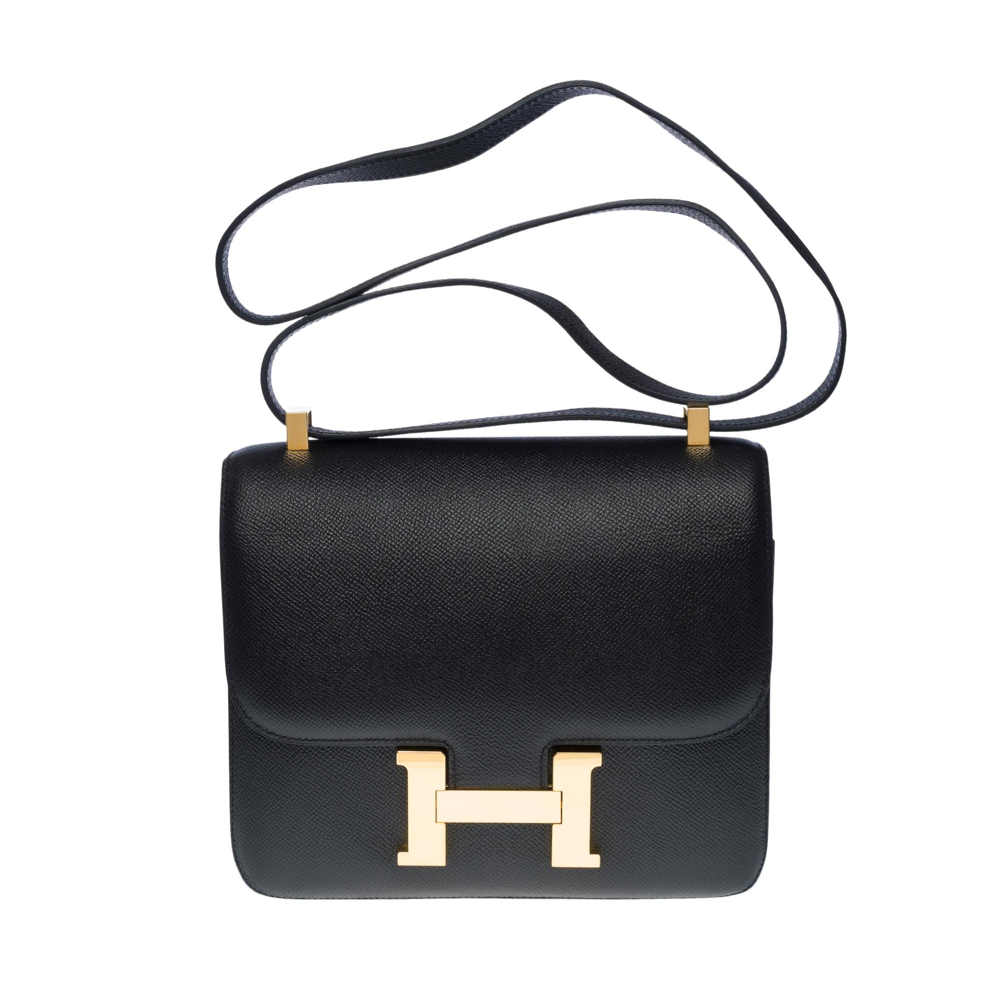 Gorgeous Hermes Constance 23 shoulder bag in black epsom leather, gold plated metal hardware, convertible handle in black epsom leather for a hand, shoulder or crossbody carry

Closure in gilded metal on flap
Black leather lining, 2 compartments,
