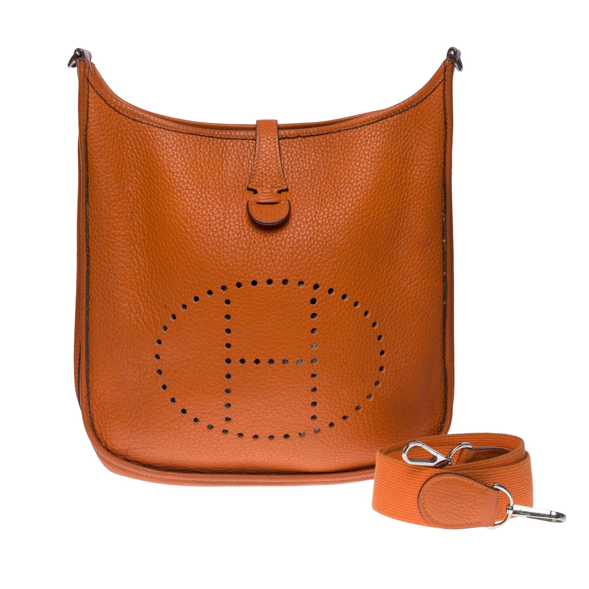 The Iconic Hermes Evelyne 29 shoulder bag in Orange Taurillon Clemence leather, silver metal hardware, Orange Canvas Removable Shoulder Strap for Shoulder or crossbody carry

Snap closure on flap
Orange suede interior
Signature: 