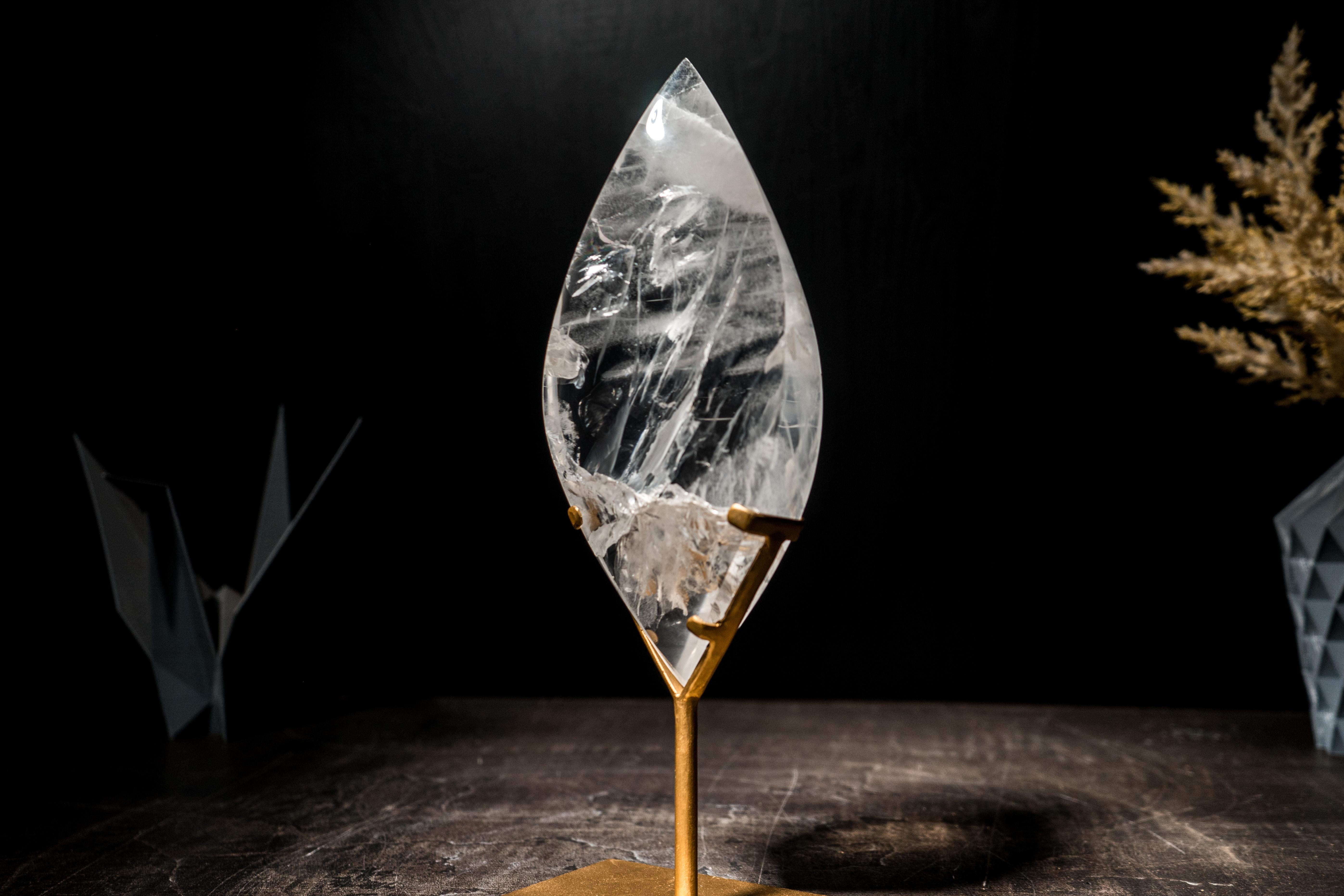 Natural Clear Quartz Flame Sculpture on Made-To-Order Stand

Through skilled lapidary work, this clear quartz has been sculpted into a beautiful, delicate flame, with a transparent crystal quartz with natural internal flaws that reflect light in