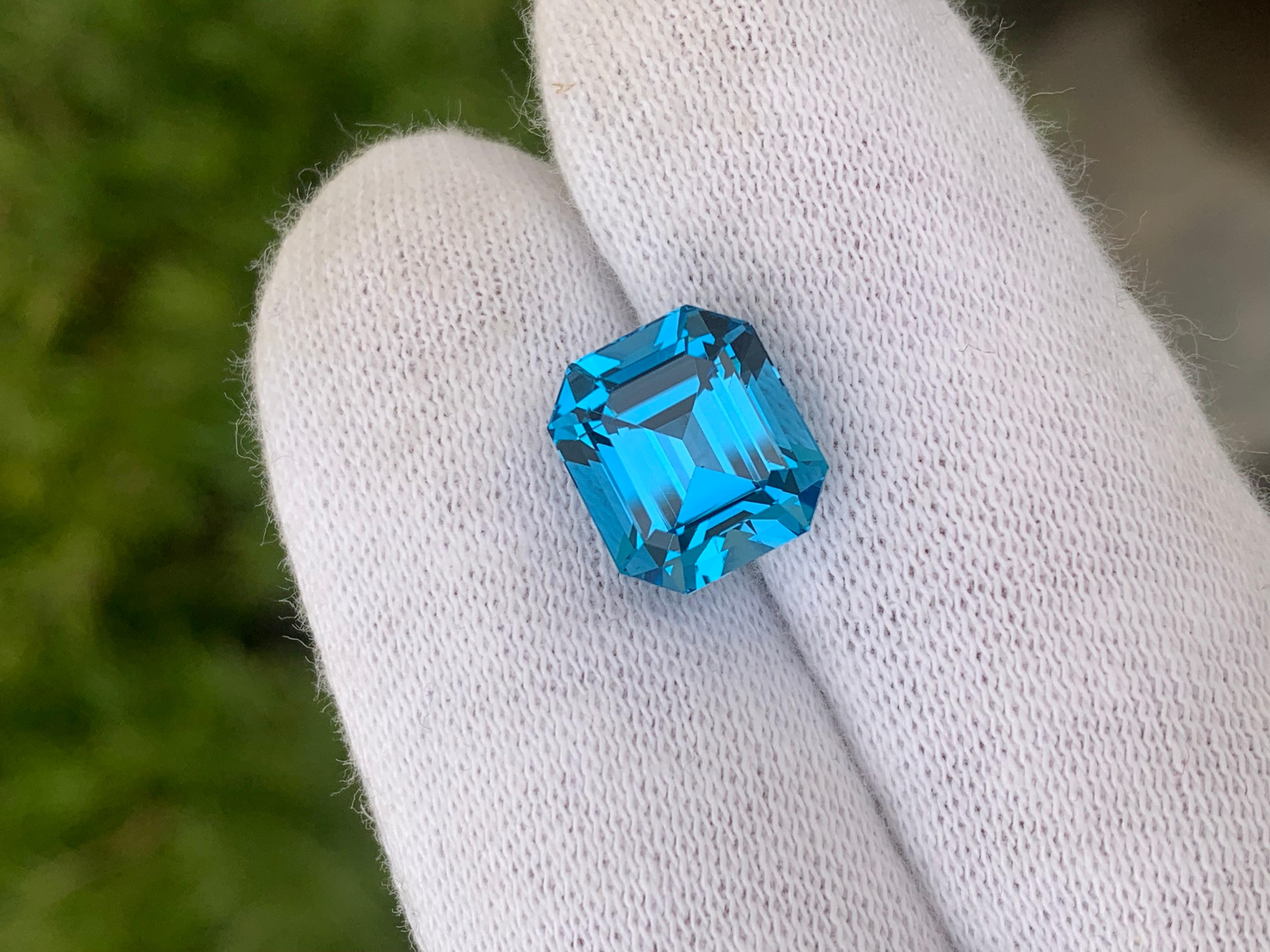 Faceted Electric Blue Topaz 
Weight : 9.10 Carats
Dimensions : 11.4x10.2x8.5 Mm
Origin : Brazil
Clarity : Loupe Clean
Shape: Emerald
Color: Intense Blue
Certificate: On Demand
Blue Topaz Metaphysical Properties
Blue topaz, in particular, is believed