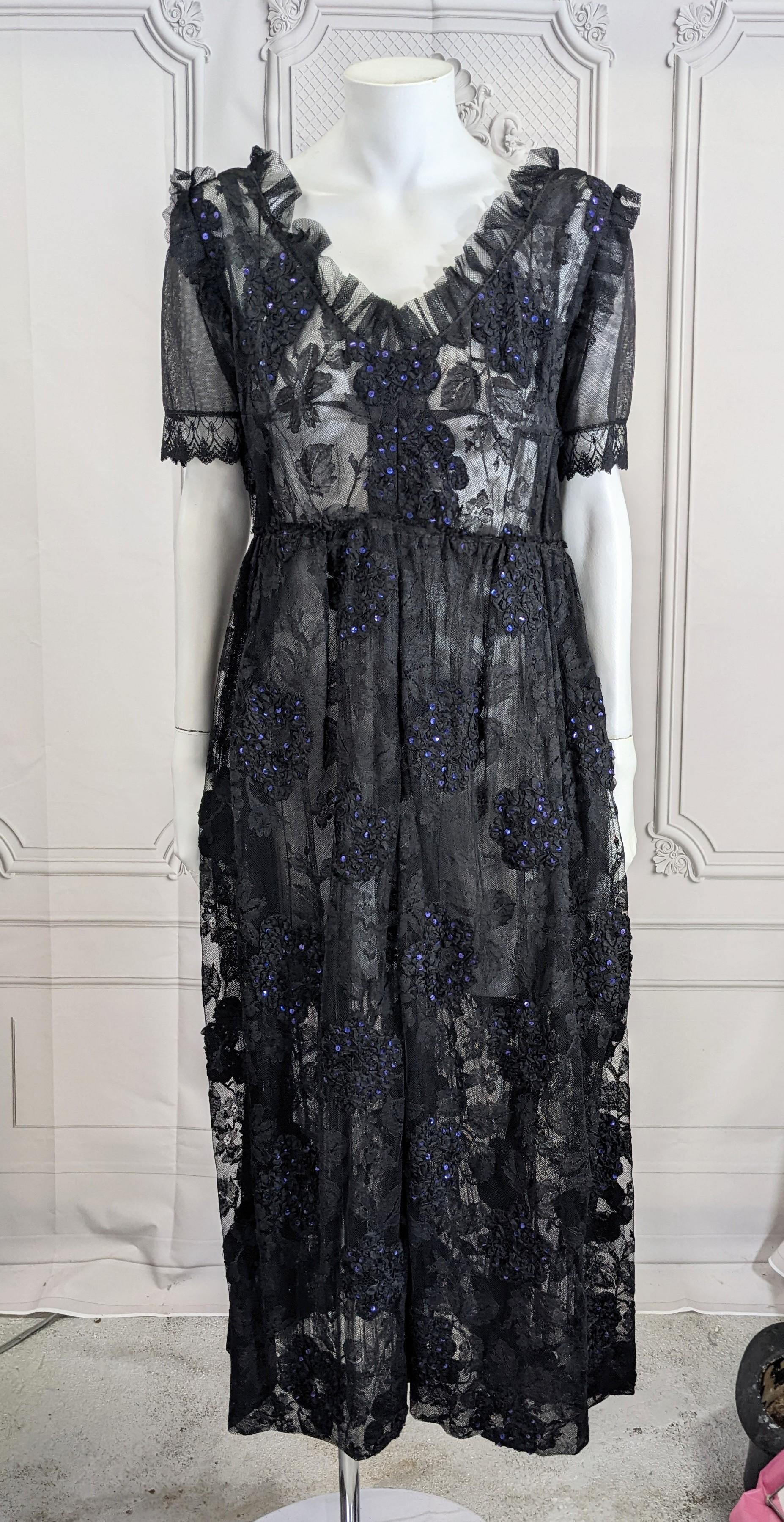 Precioso Vestido de Encaje y Lentejuelas de Hortensia de los años 60. Precioso encaje francés con una superposición de hortensias trabajadas con cintas y salpicadas de lentejuelas violetas. Cortado en forma de baby doll con cintura alta y falda