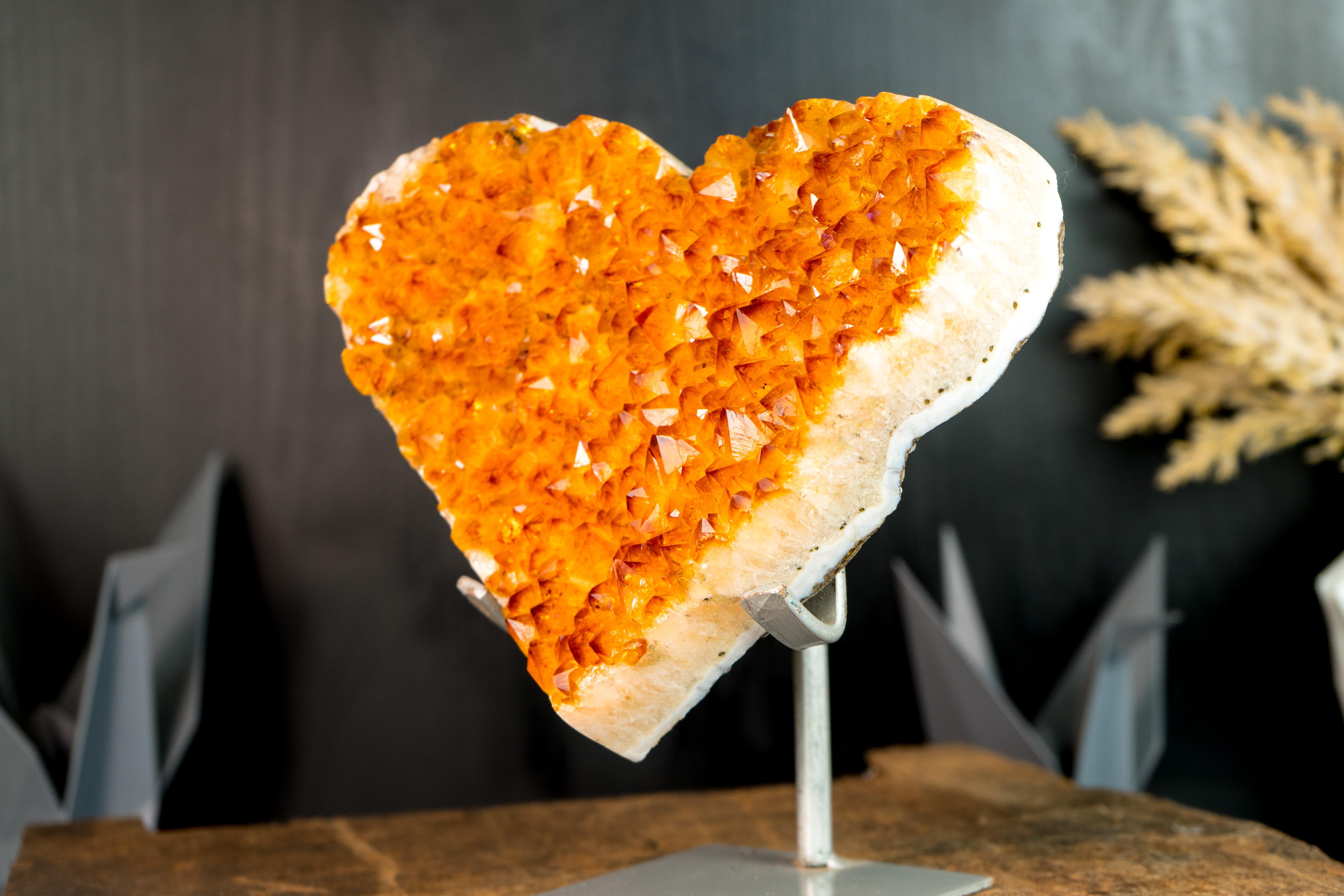 Carefully hand-carved from a single Citrine cluster, this radiant Citrine heart showcases wonderful aesthetics with its sparkly Druzy. It is a Citrine specimen that will become a gorgeous decor piece for your console, desk, or shelf. Additionally,
