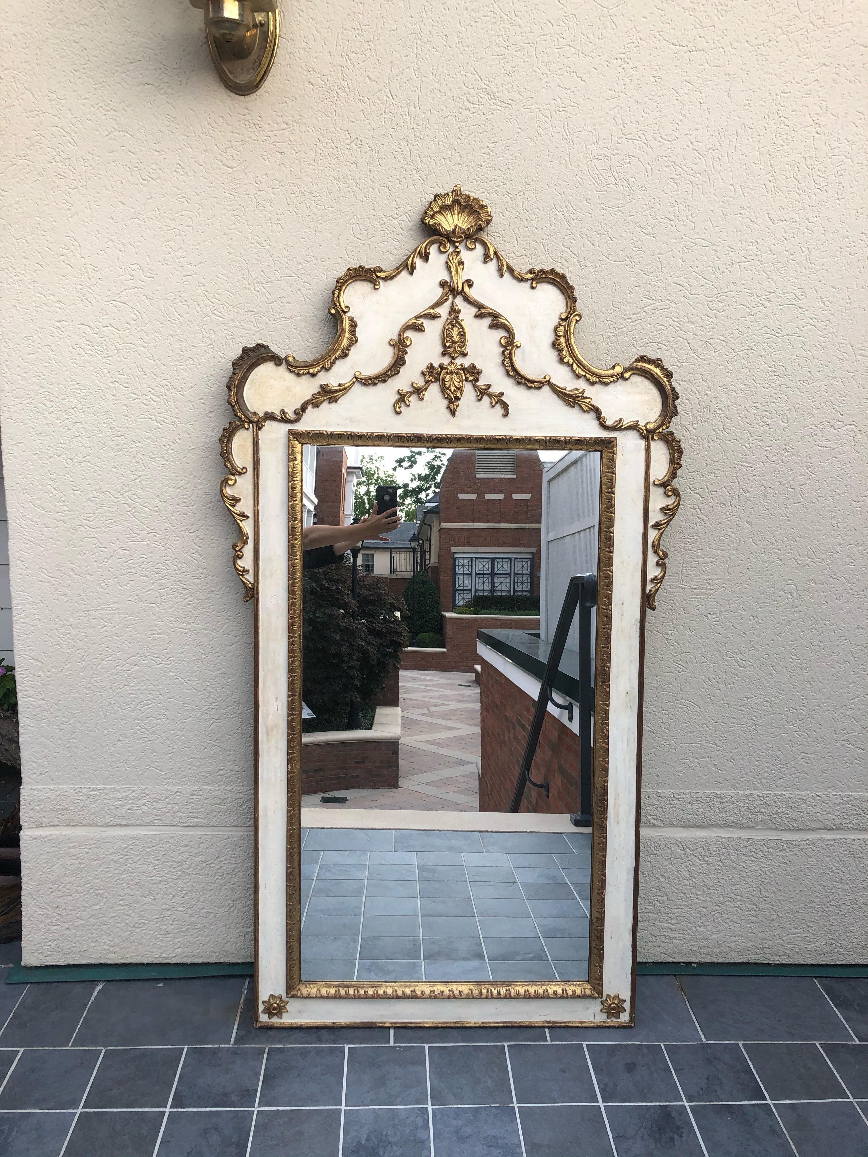 Striking large Gustavian style painted and giltwood mirror having lovely curved top with shell decoration at the top.

Crown itself measures 18.5” high x 34” wide
Actual mirror alone measures- 22” wide x 41” high.