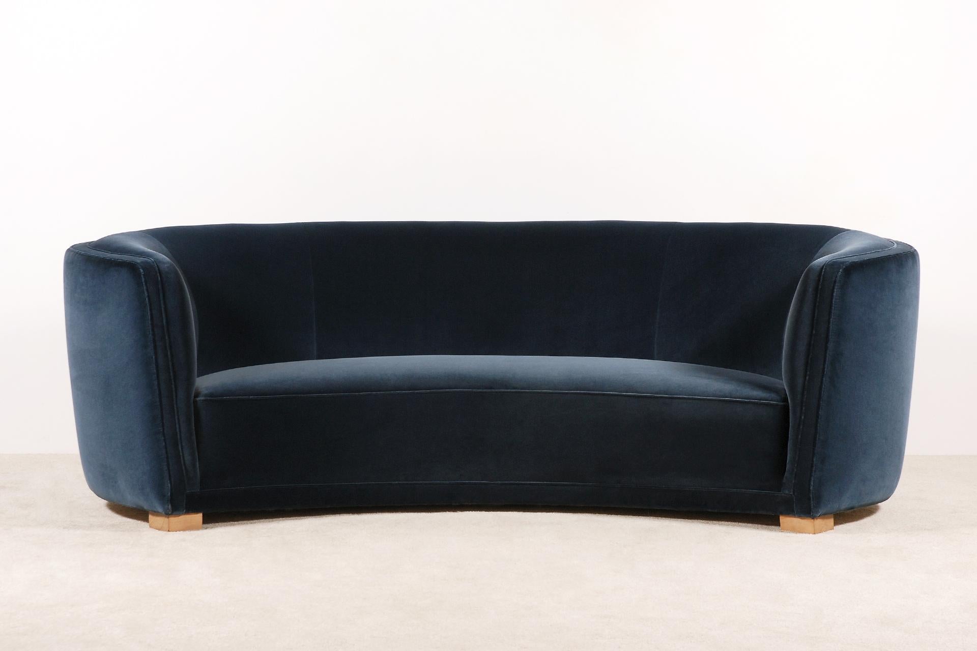 Exceptional and unique piece.
Large three-seat curved sofa manufactured in Denmark during the 1930s.
Lovely shape and curves. Very comfortable seat.
Natural color waxed beech feet.

This sofa has been fully restored and newly upholstered in the