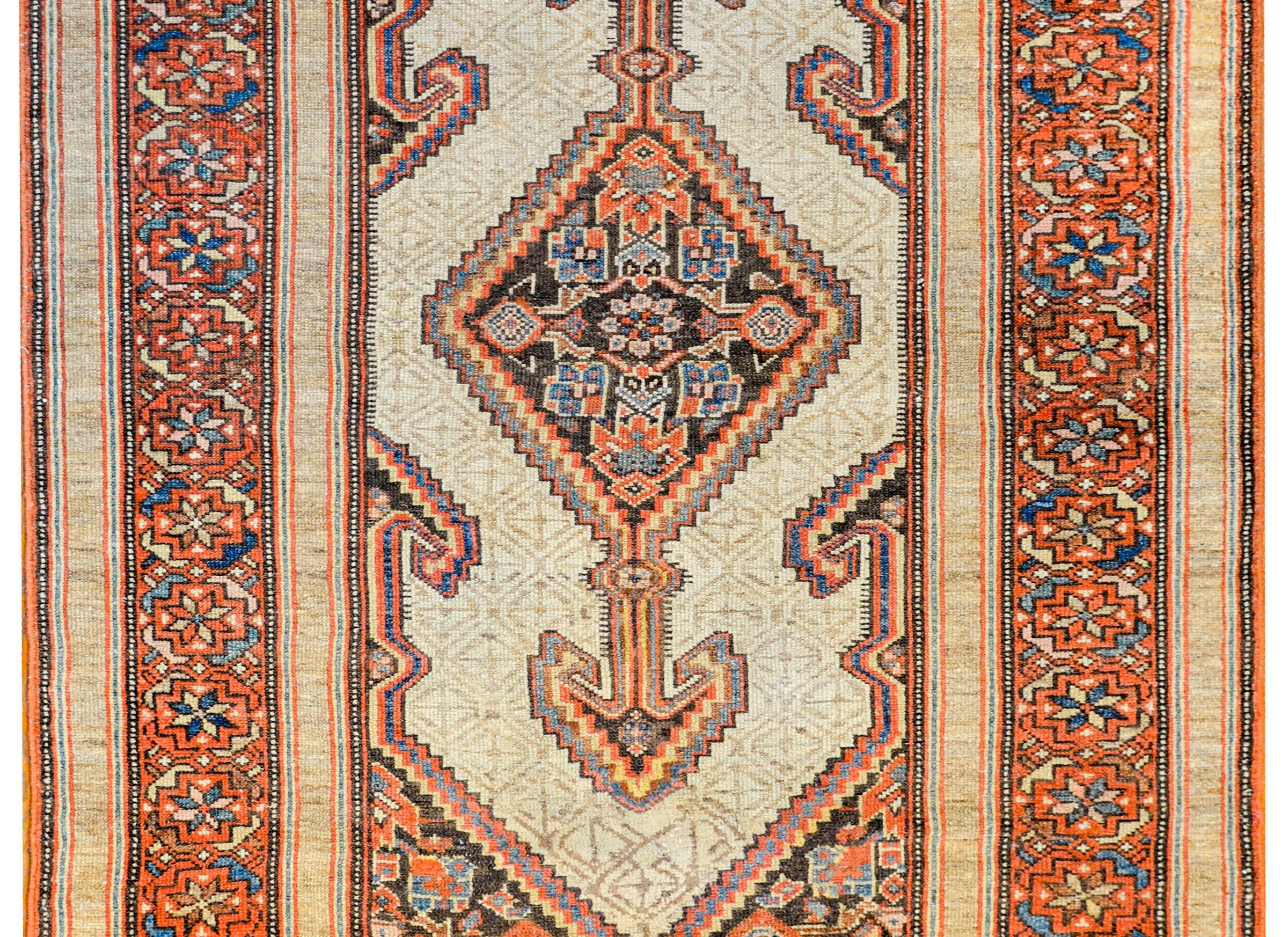 A gorgeous late 19th century Persian Serab rug with an incredible skillfully woven pattern. There is one wonderful diamond medallion, each composed with flowers, shrimp, and stylized vines. The medallions are on a sophisticated field of camel hair