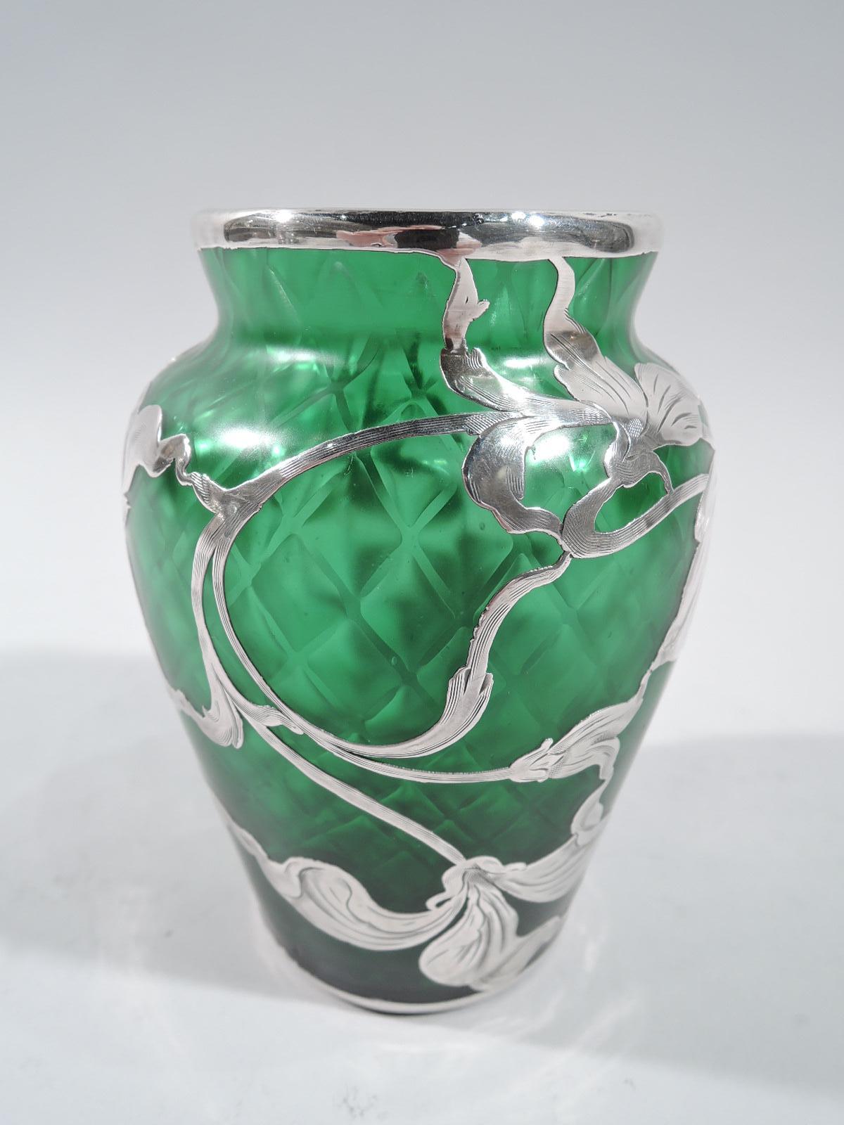 Gorgeous turn-of-the-century Art Nouveau quilted glass vase by historic maker Loetz with engraved silver overlay. Gently tapering sides and short inset neck. Loose and fluid floral overlay. An open and dynamic design with irregular petals and