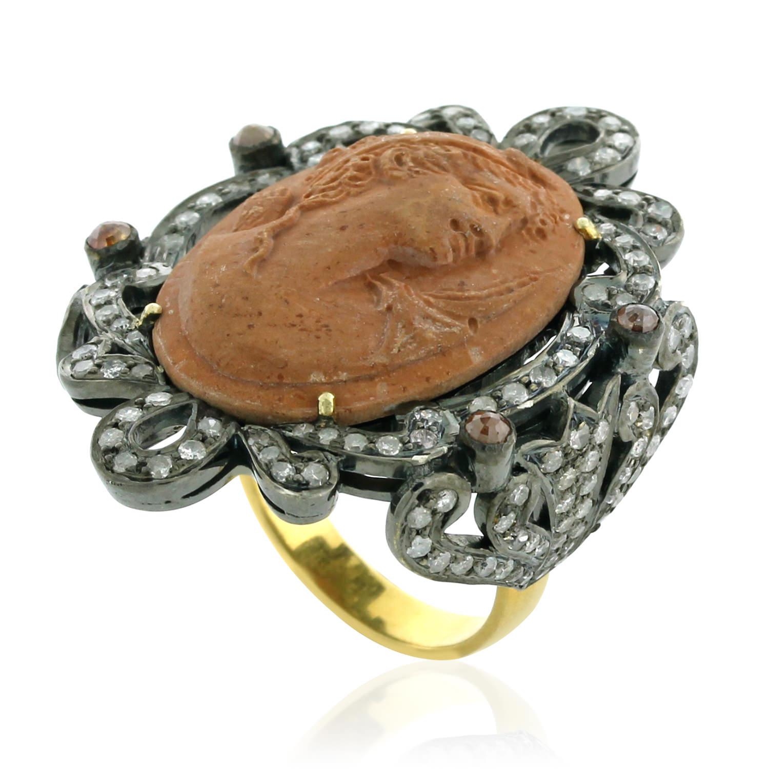 This gorgeous looking Lava Cameo Ring with Diamonds set in silver and gold is all hand carved and handmade truly a unique one.

Ring Size: 7 ( can be sized )

18kt gold: 2.59gms
Diamond: 1.77cts
Silver: 7.77gms
Cameo : 14.50cts
