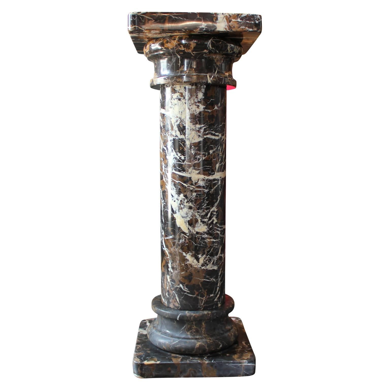 Gorgeous marble display or pedestal. Deep brown and black detail within the marble. Can be used as a pedestal or display for art and other objects.