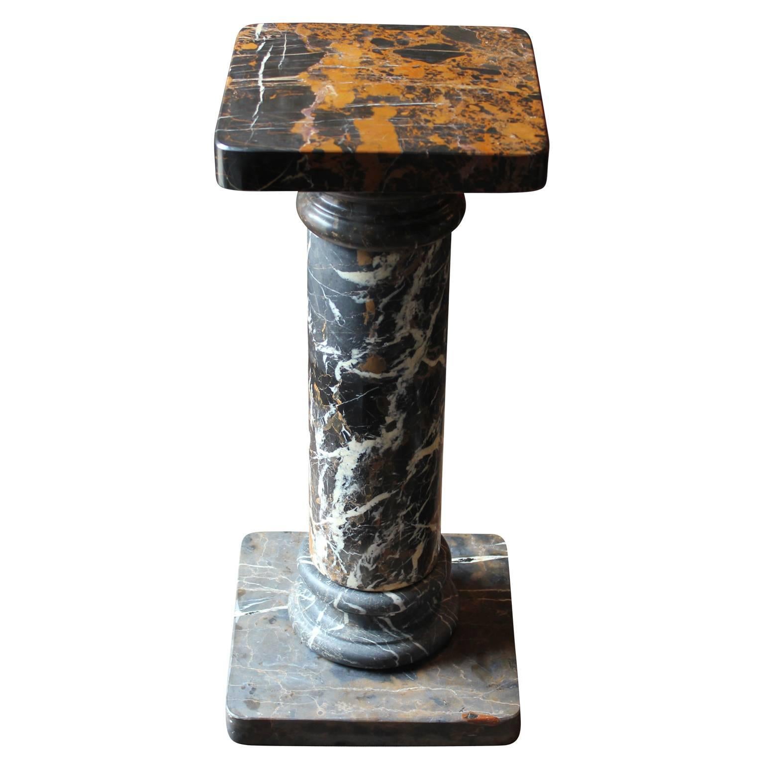 Gorgeous marble display or pedestal. Deep brown and black detail within the marble. Can be used as a pedestal or display for art and other objects.