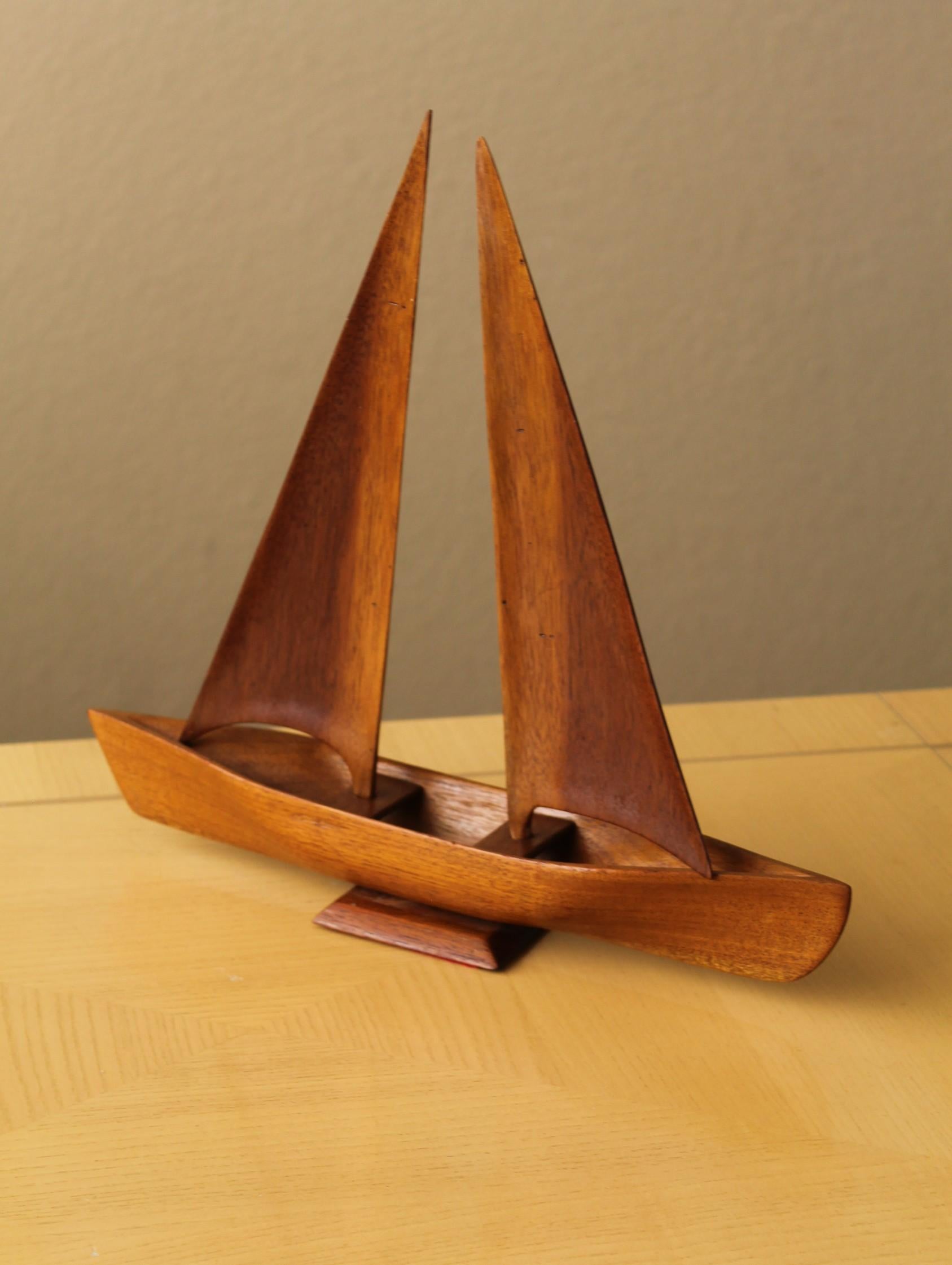 Immaculate!

Danish Modern
Teak Sail boat Sculpture
With Removable/Articulating Sails

Circa 1960

Here is a simply fabulous Danish Modern teak sail boat sculpture!  Incredible workmanship and gorgeous teak make for an incredible presentation!

This