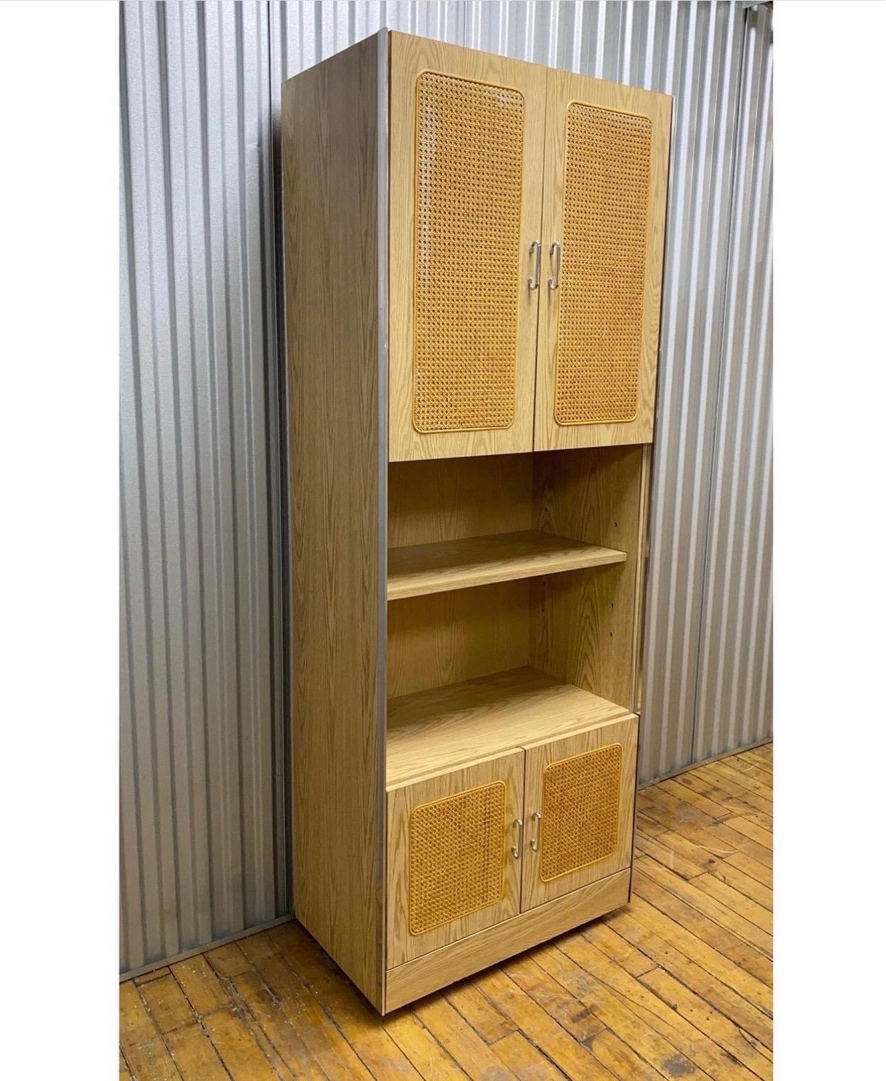 Gorgeous mid-century oak, cane & chrome wall unit featuring adjustable shelving.

Absolutely love this piece! Has ample room for storage as shown. Really heavy and well constructed!

Measures: H 78”
W 30”
D 16”