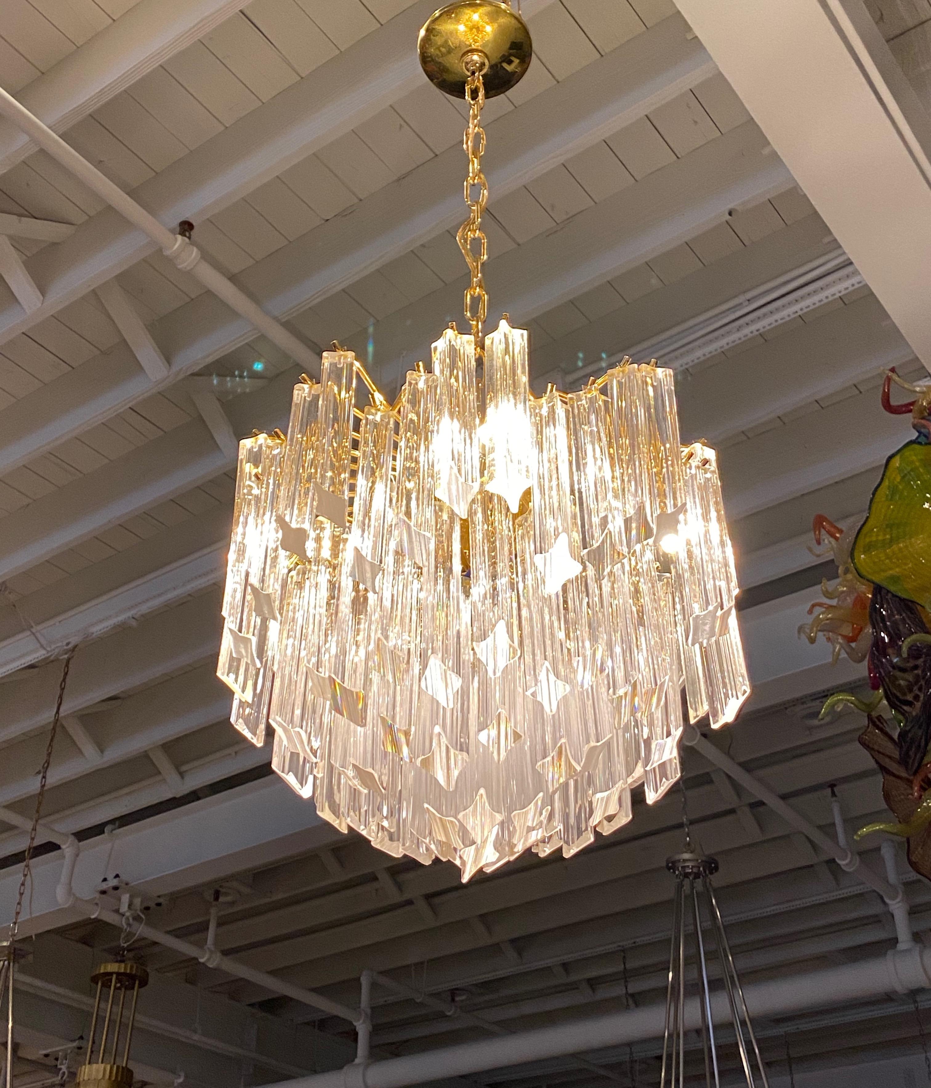 Mid-Century Modern Italian round chandelier. Each of the prisms are solid glass. They hang beautifully from hooks on a brass frame, as pictured. Any amount of chain can be added for custom hanging length of the chandelier. A pole can be switched out