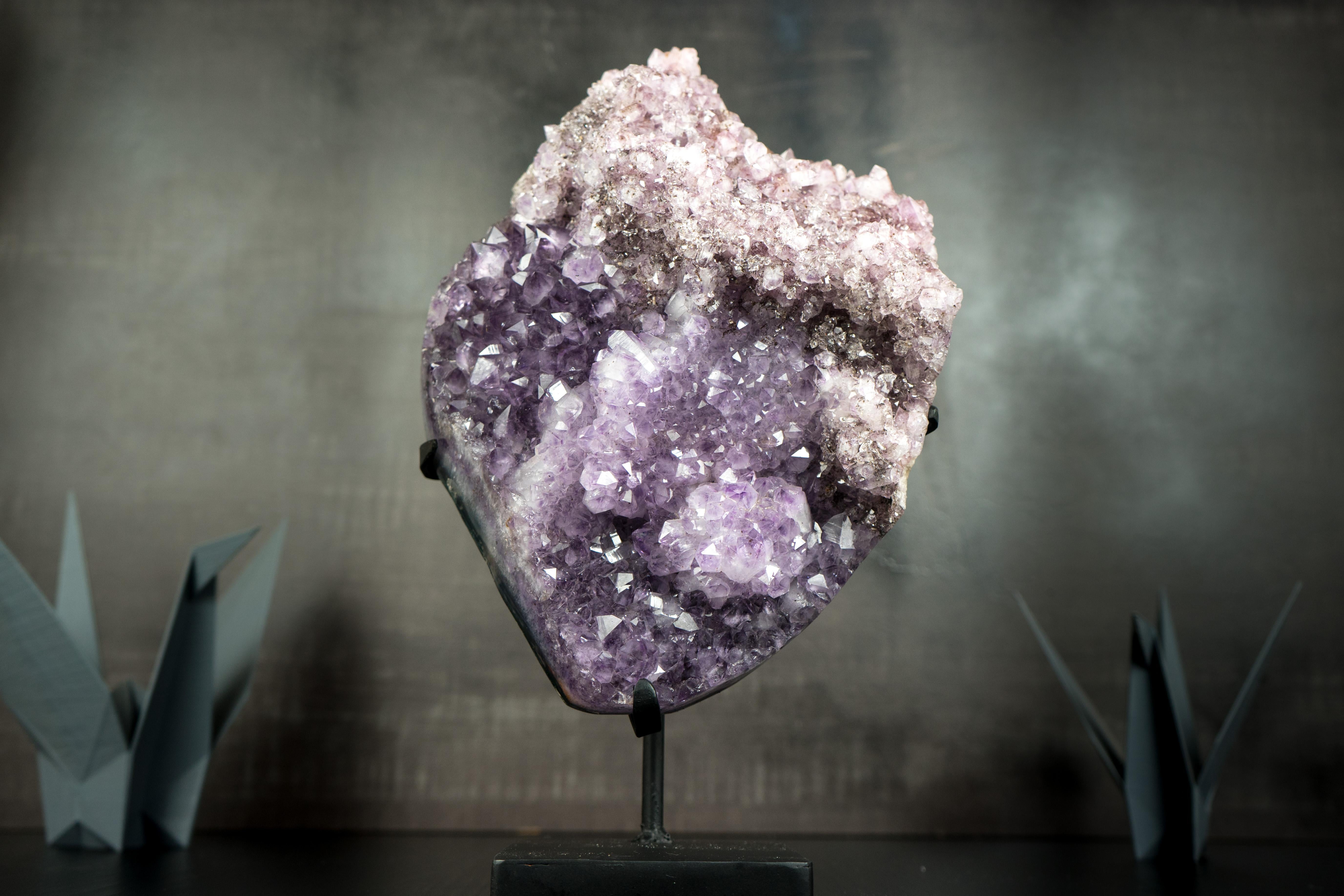 A rare Amethyst Cluster that could be in a Gallery, at a fine decor, or become a display specimen at a collection, this specimen brings us a rarely seen crown of Herkimer-Style, shiny Amethyst Druzy growing on top of a multi-colored Amethyst druzy.