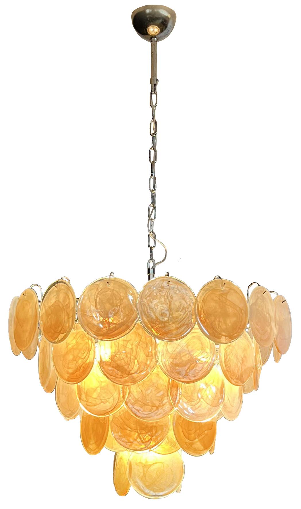 Italian Murano chandelier. The chandelier has 57 Murano ridescent alabaster honey discs in a nickel metal frame.. The glasses are now unavailable, they have the particularity of reflecting a multiplicity of colors, which makes the chandelier a true