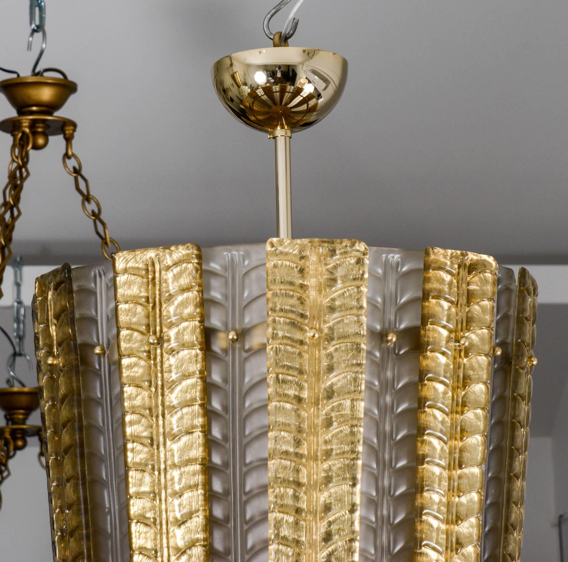 Murano glass lantern in pressed glass, gold patina.

Six bulbs.