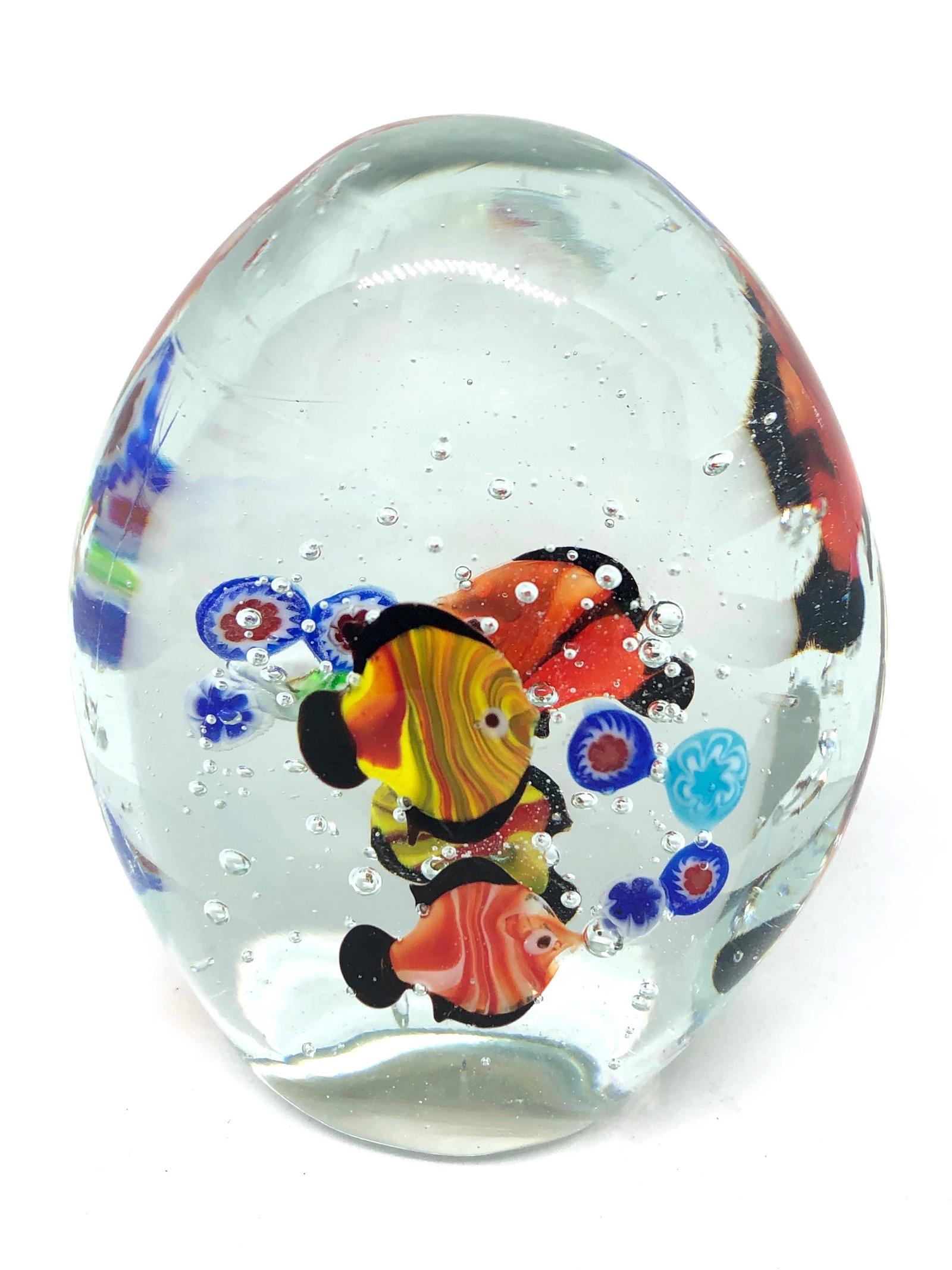 Beautiful Murano hand blown aquarium Italian art glass paper weight. Showing some multicolored fishes, floating on controlled bubbles. Colors are a blue, orange and clear. A beautiful nice addition to your desktop or as a decorative piece in every