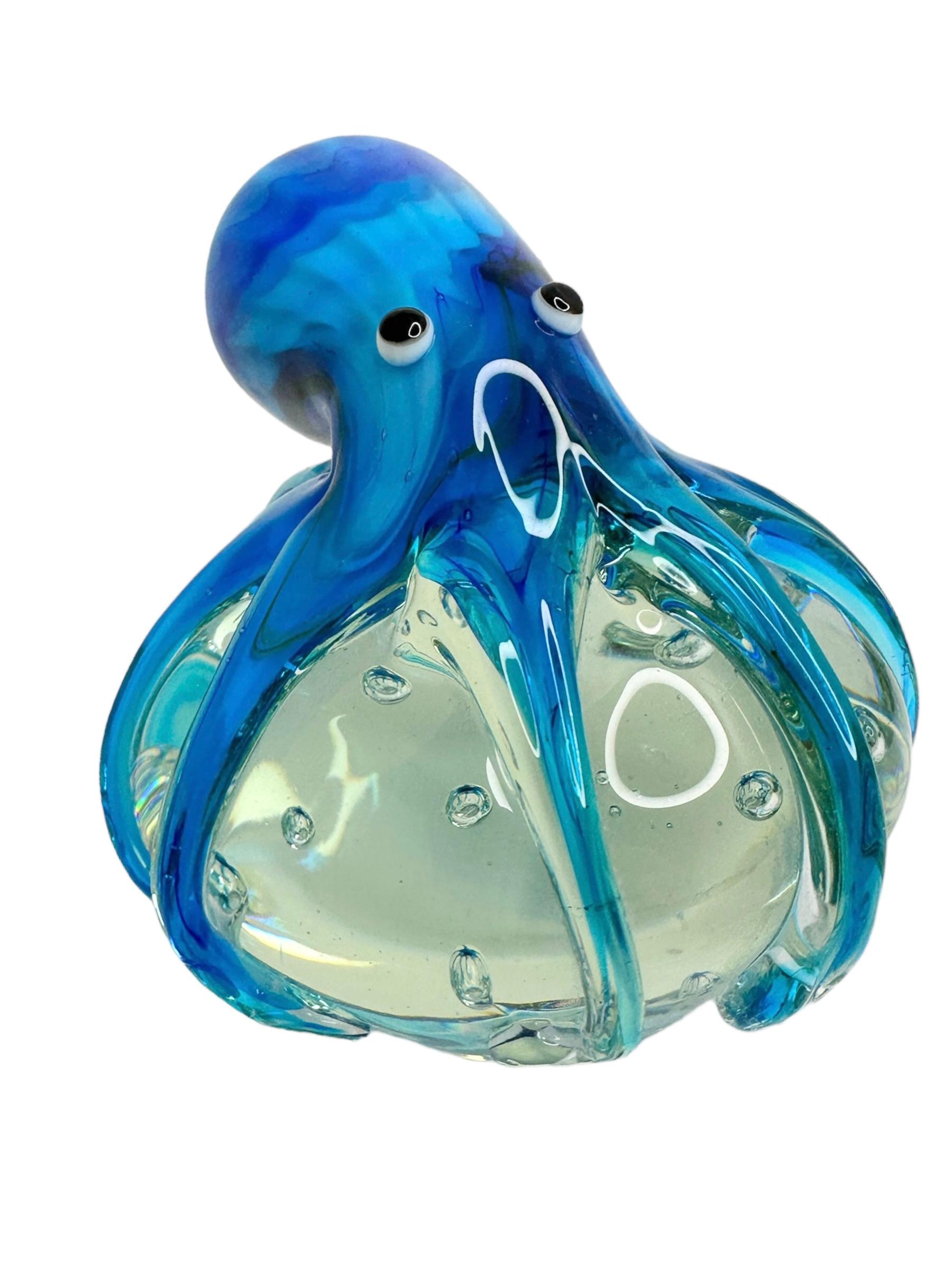 Beautiful Murano hand blown aquarium Italian art glass paper weight. Showing a giant octopus, on a glass bubble floating on controlled bubbles. Colors are different shades of blue, white, black and clear. A beautiful nice addition to your desktop or