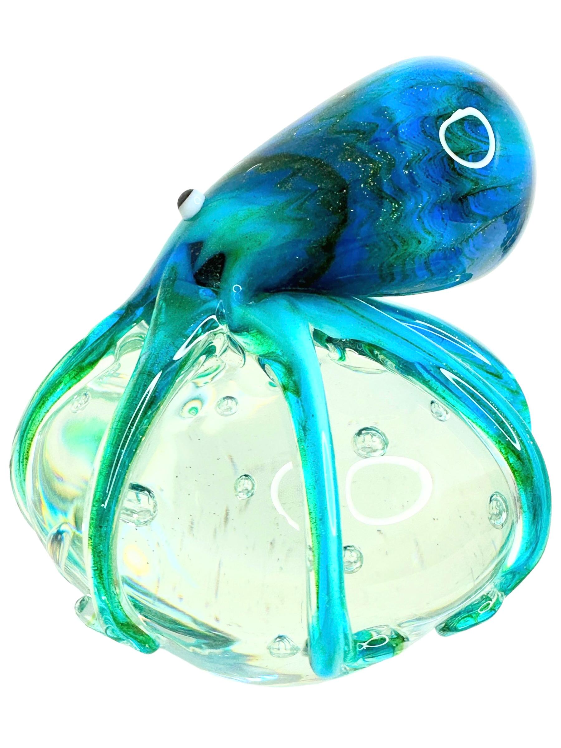 Beautiful Murano hand blown aquarium Italian art glass paper weight. Showing a giant octopus, on a glass bubble floating on controlled bubbles. Colors are different shades of blue, turquoise, white, black and clear. A beautiful nice addition to your