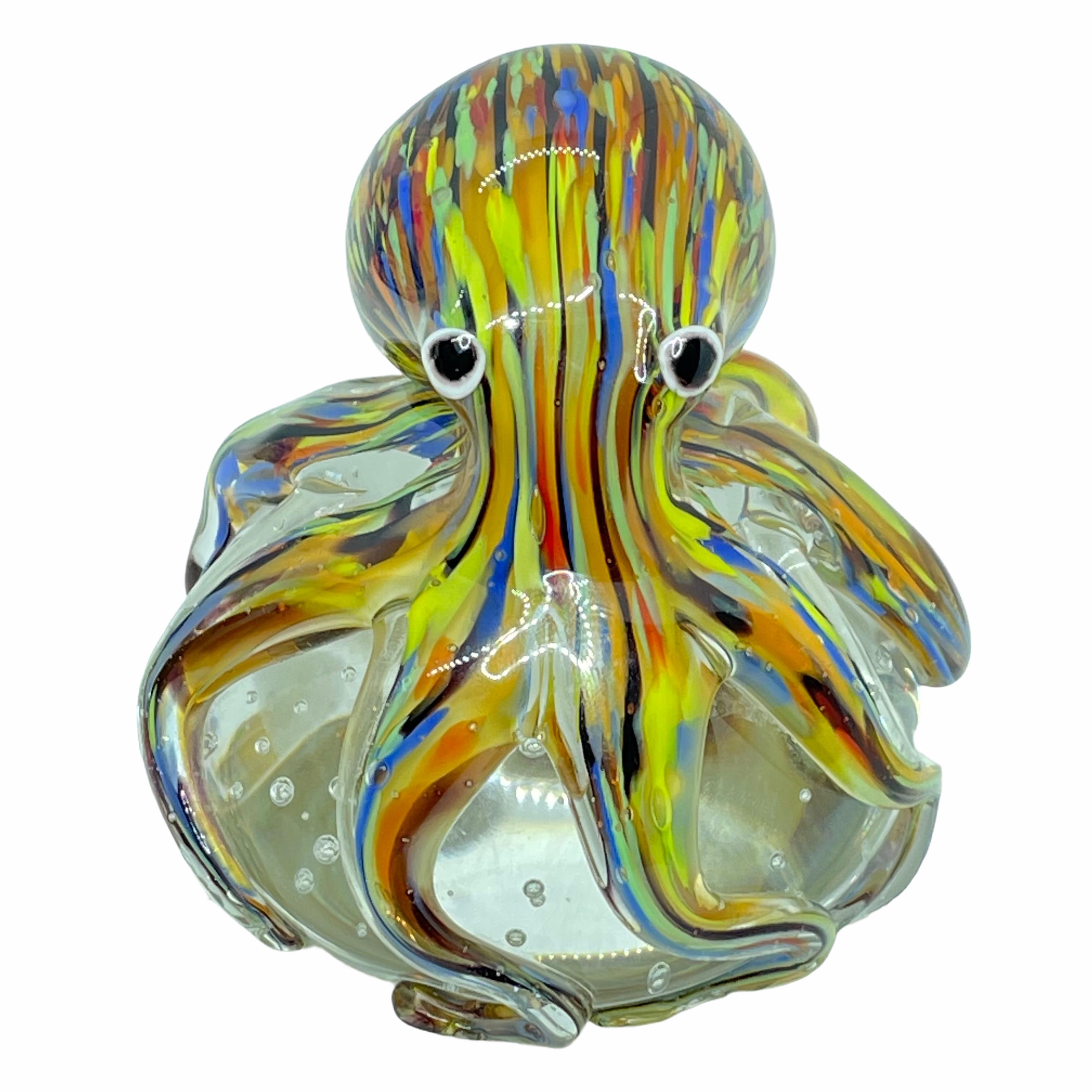 Beautiful Murano hand blown aquarium Italian art glass paper weight. Showing a giant octopuses, on a glass bubble floating on controlled bubbles. Colors are a blue, yellow, orange and clear. A beautiful nice addition to your desktop or as a