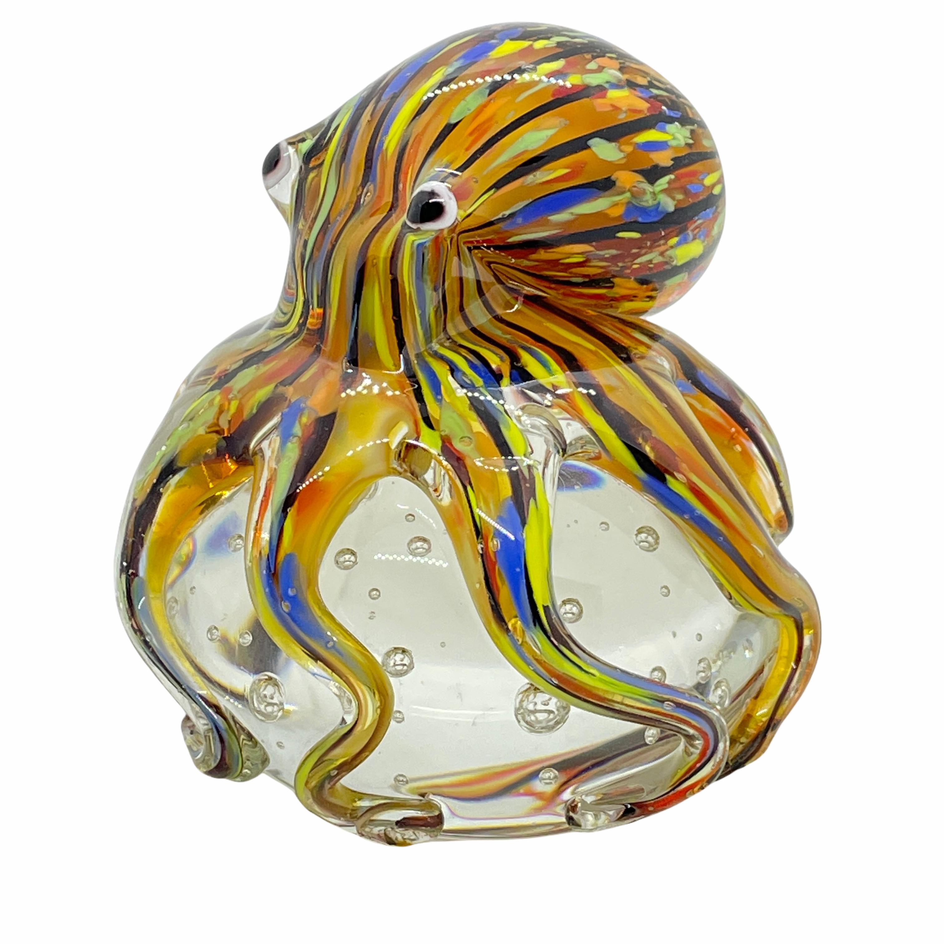 Beautiful Murano hand blown aquarium Italian art glass paper weight. Showing a giant octopuses, on a glass bubble floating on controlled bubbles. Colors are a blue, yellow, orange and clear. A beautiful nice addition to your desktop or as a