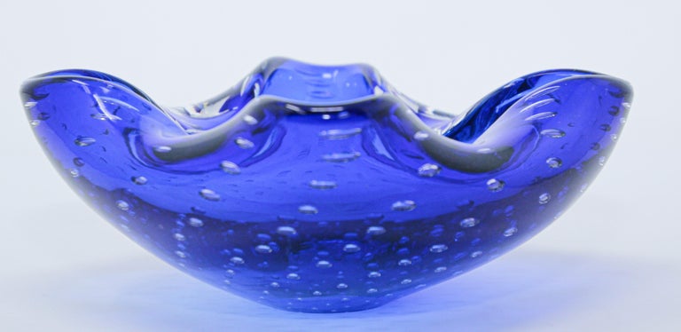 Gorgeous Vintage Murano Venetian handblown art glass with bubbles flower shaped bowl or ashtray. 
Sculptural organic open flower form in cobalt blue art glass ashtray bowl.
Use it as an ashtray, vide poche or for decorative bowl or paper weight.
   