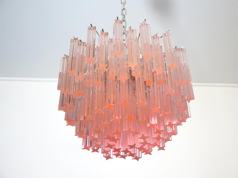Fantastic vintage Murano chandelier made by 107 Murano crystal prism quadriedri in a nickel metal frame. The glass has a slightly pink color.
Period: 1980s
Dimensions: 45.25 inches height (115 cm) with chain, 15.75 inches height (40 cm) without