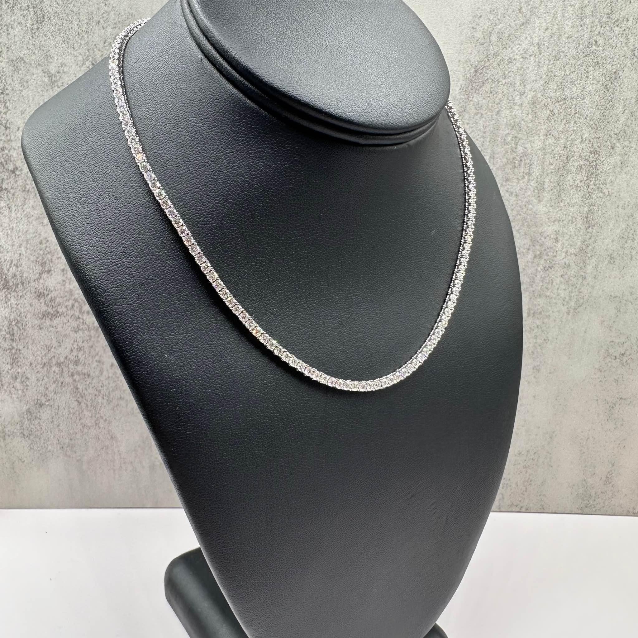 This Gorgeous Natural Diamond Tennis Necklace in 14kt white gold features 9.12 carats of natural GH SI round diamonds, offering stunning sparkle and elegance. The 16-inch length sits perfectly around the neckline, making it ideal for special