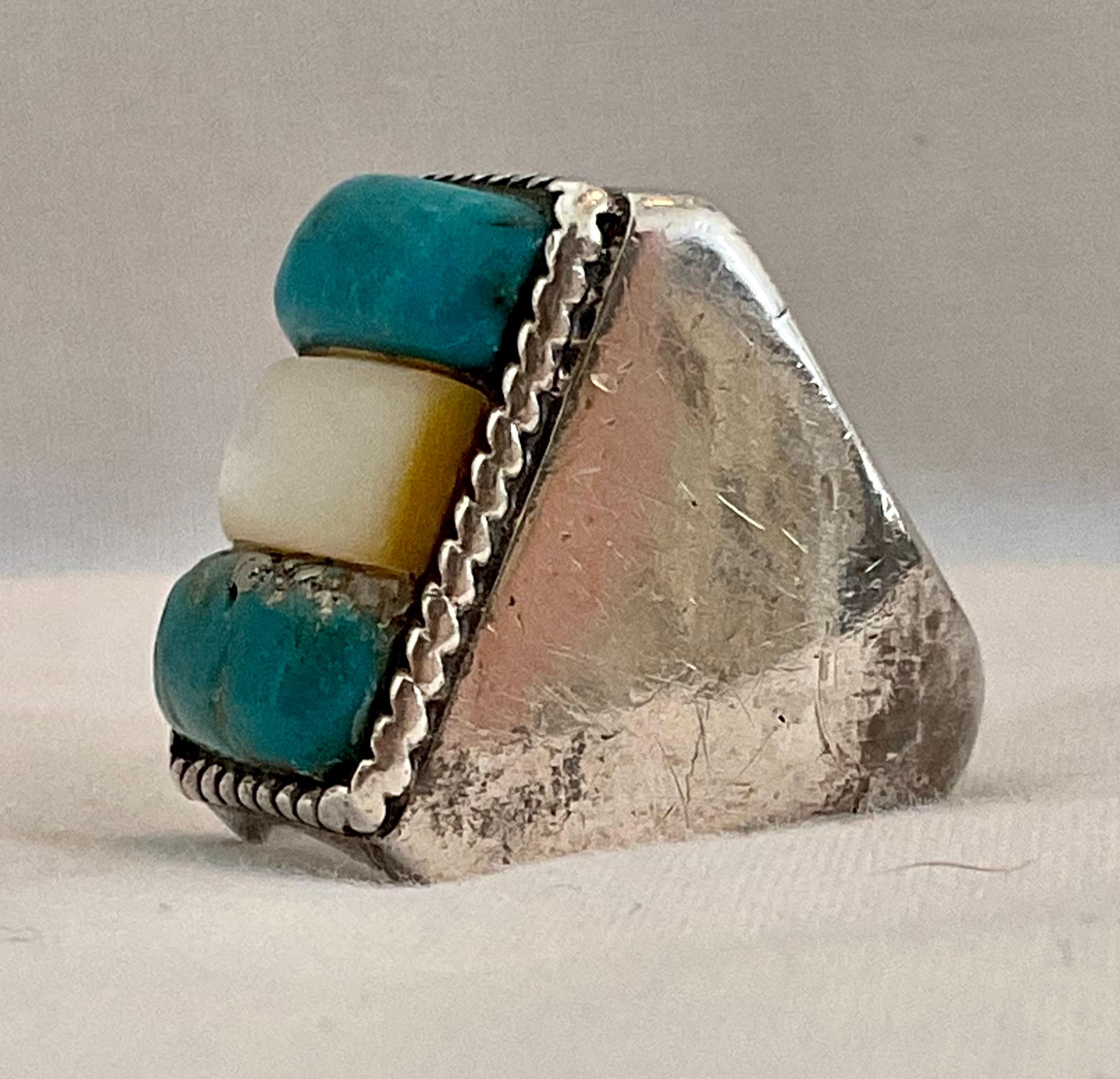 This Native American men's ring is one of a kind, as are the majority of my pieces. There are two incredible bands of turquoise with a mother of pearl centerpiece. Each band measures approximately 5/8