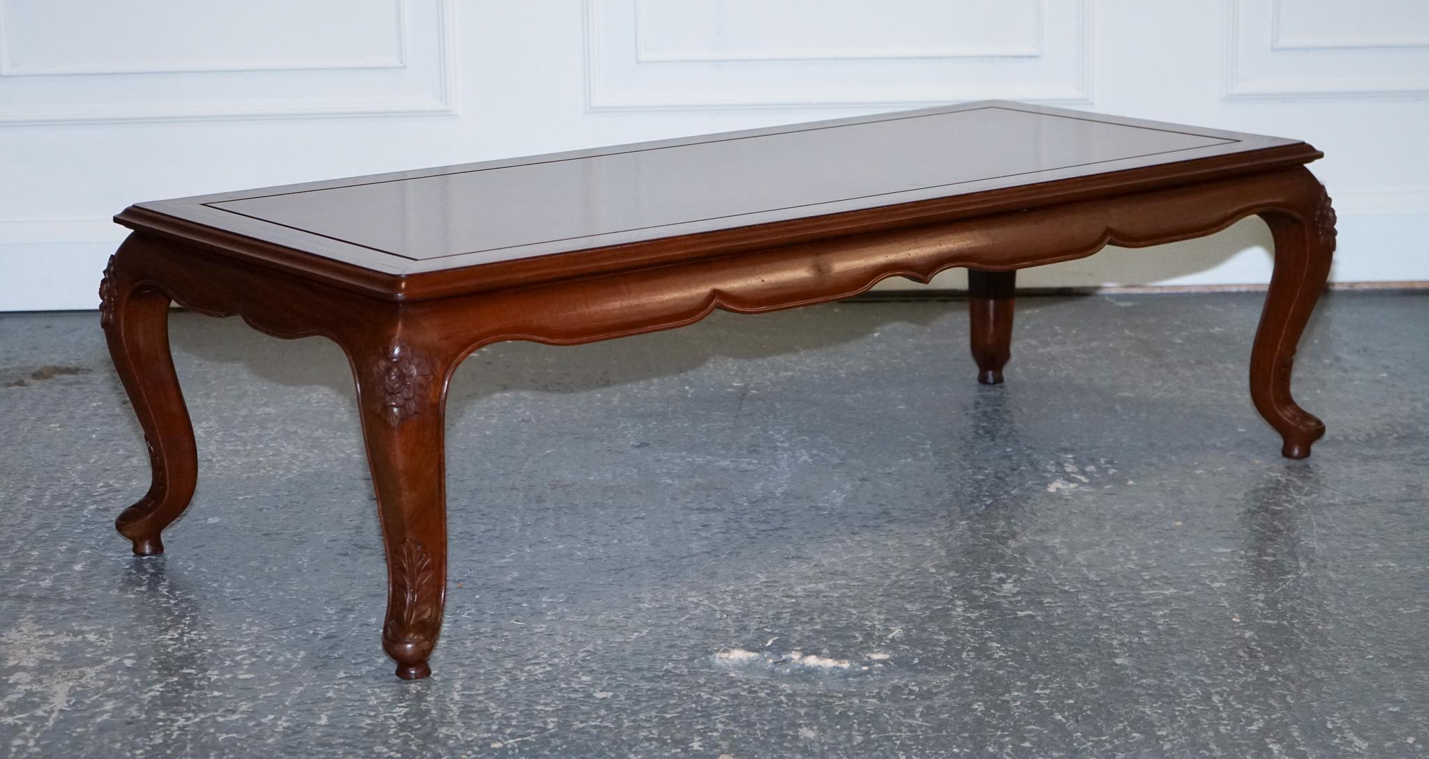 We are delighted to offer for sale this Lovely Oriental Hardwood Coffee Table With Brass Inlay and Hand Carved legs.

This Oriental rectangular coffee table is the epitome of style and class. 
The table top is adorned with brass lines, creating a