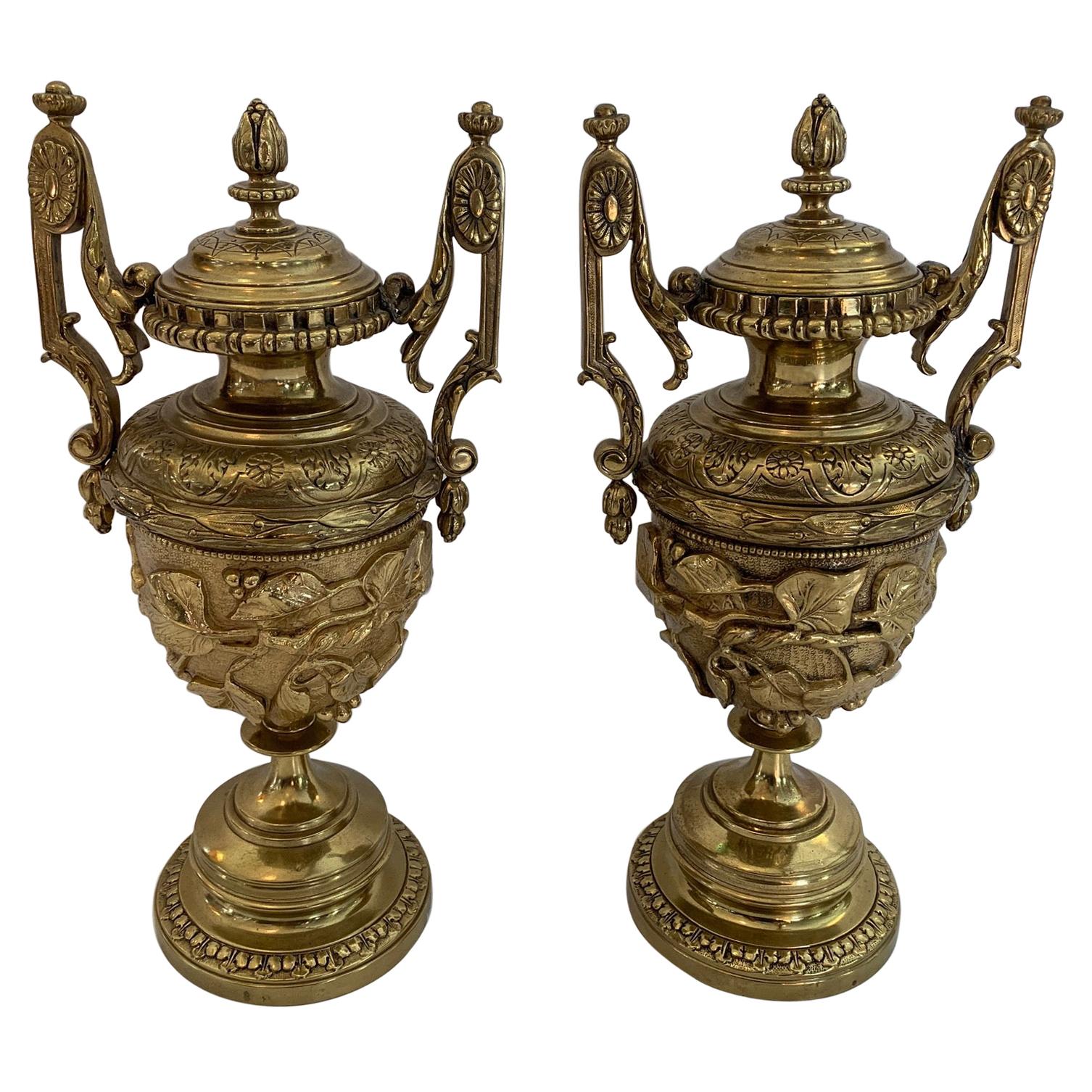 Gorgeous Ornate Pair of Revival Style Cast Brass Relief Lidded Urns For Sale