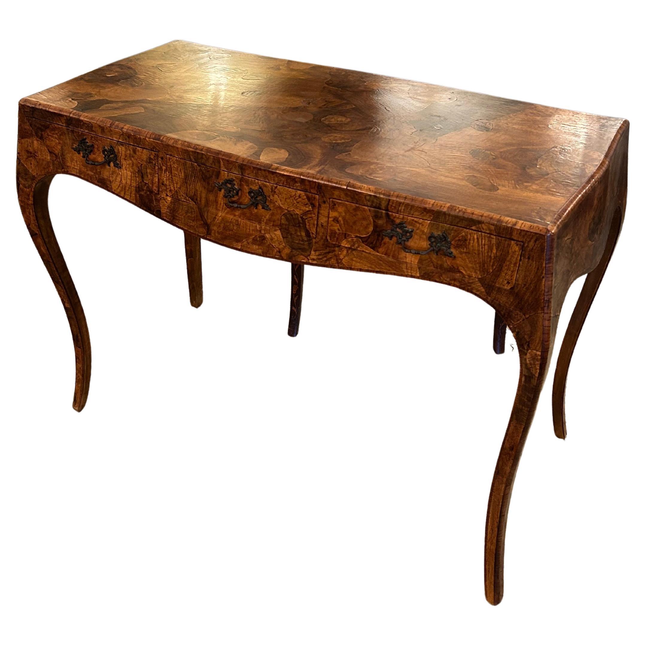 Superbly elegant medium sized writing desk made of gorgeously grained oyster wood, having 3 drawers, lovely thin cabriole legs, and finished on the back.
Surface is 39.5 w
Apron for leg room is 23.25

TS