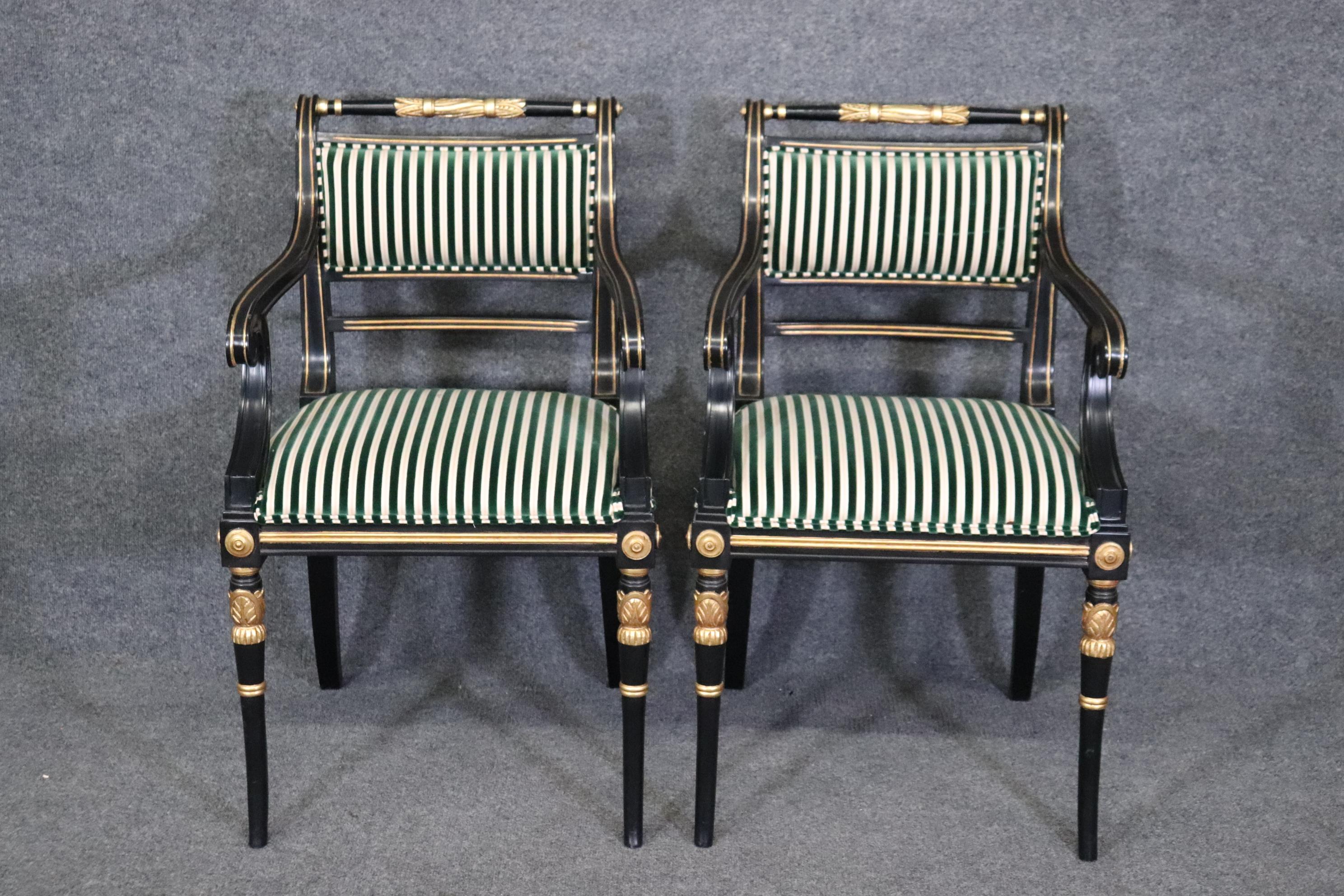 This is a gorgeous pair of head chairs for a dining table or possibly for a living room. The chairs are done in lustrous black lacquer and has gorgeous genuine gold leaf detailed carved areas for highlights. The chairs are in good condition and date