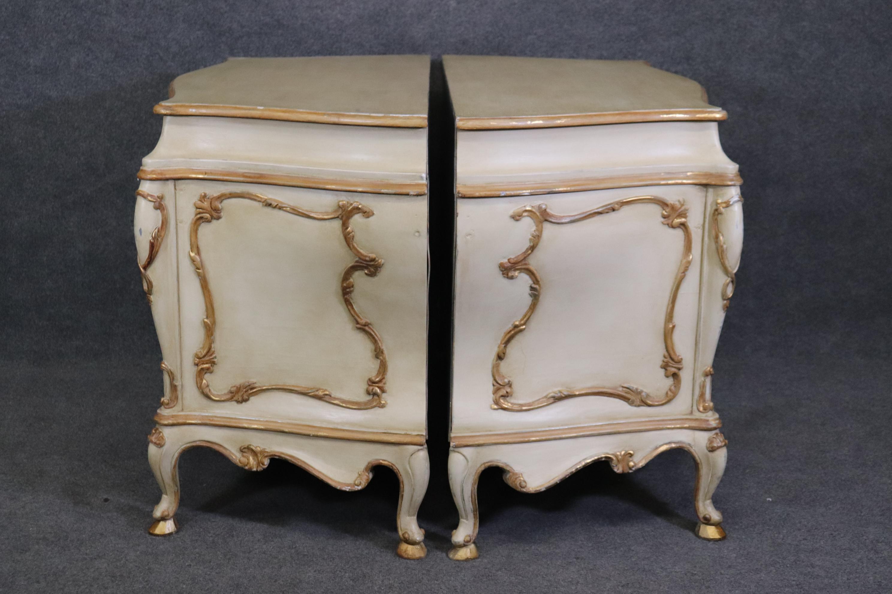 This is a gorgeous pair of antique white paint decorated commodes with gold accents. The pair is in good condition for their age and measure 49.25 wide x 22 deep x 32.25 tall. They date to the 1950s. 