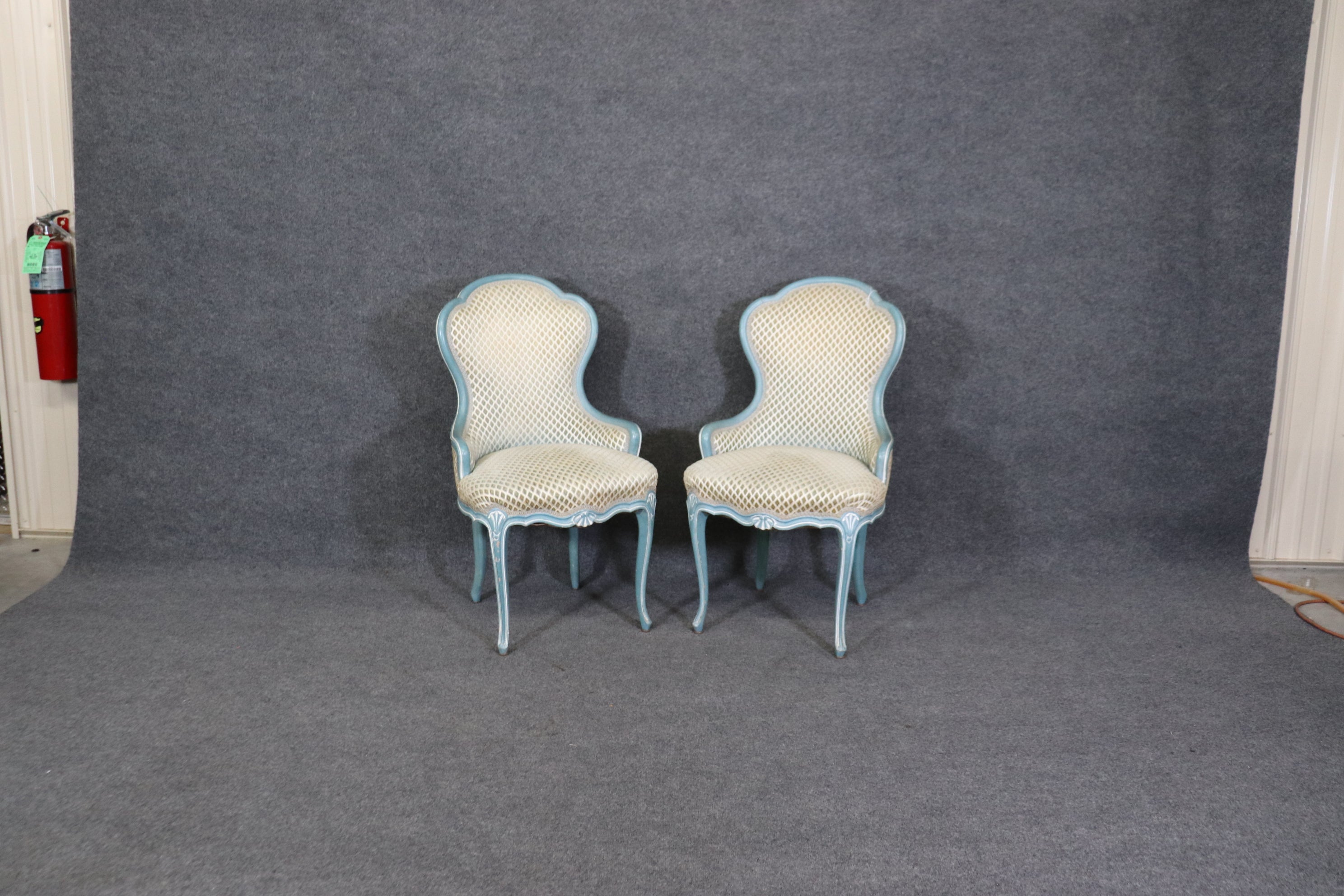 These are gorgeous chairs with fantastic painted frames in blue and white. The chairs date to the 1950s era and are in good vintage condition. The upholstery is early so expect signs of wear and use such as stains or wear. The chairs measure 36 tall