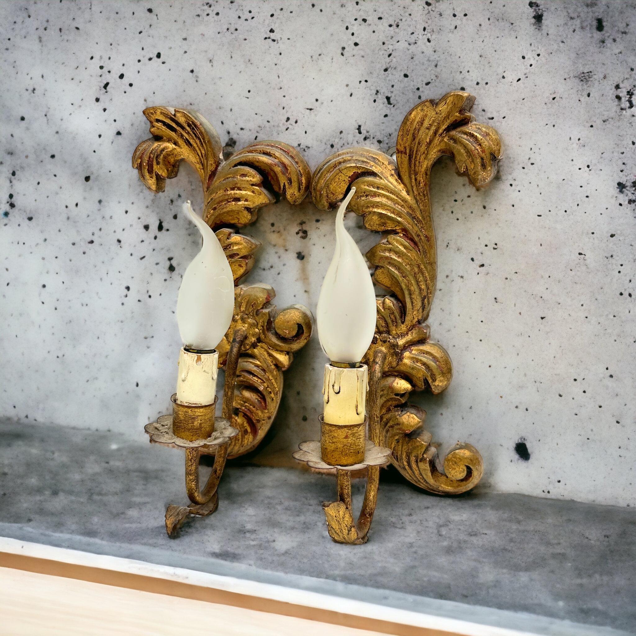 Add a touch of opulence to your home with this charming pair of sconces. Perfect gilded wood and metal to enhance any chic or eclectic home. We would like to see it hanging in an entryway as a charming welcome home. Constructed in the 1910s or