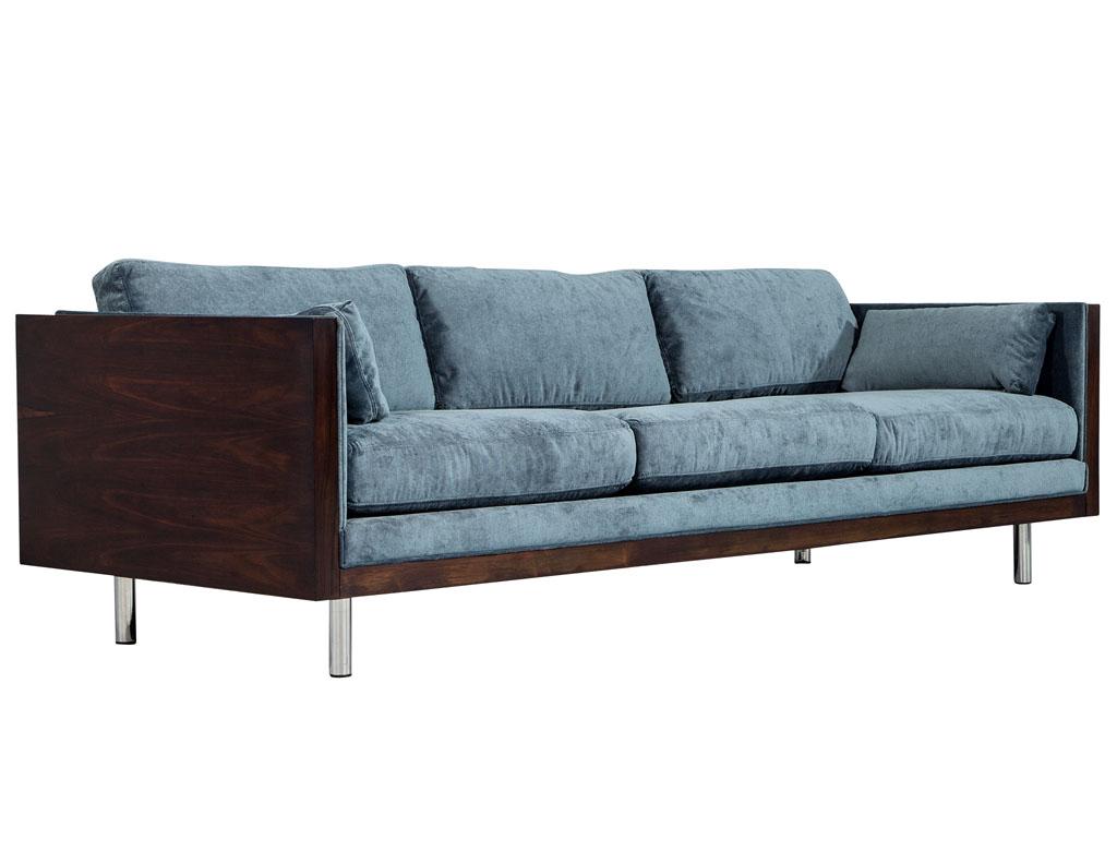 Incredibly unique and rare pair of Milo Baughman sofas. Original wood case with original chrome legs, these sofas have been restored by our Carrocel master craftsmen, with a hand polished finish and upholstered with a luxurious designer slate blue