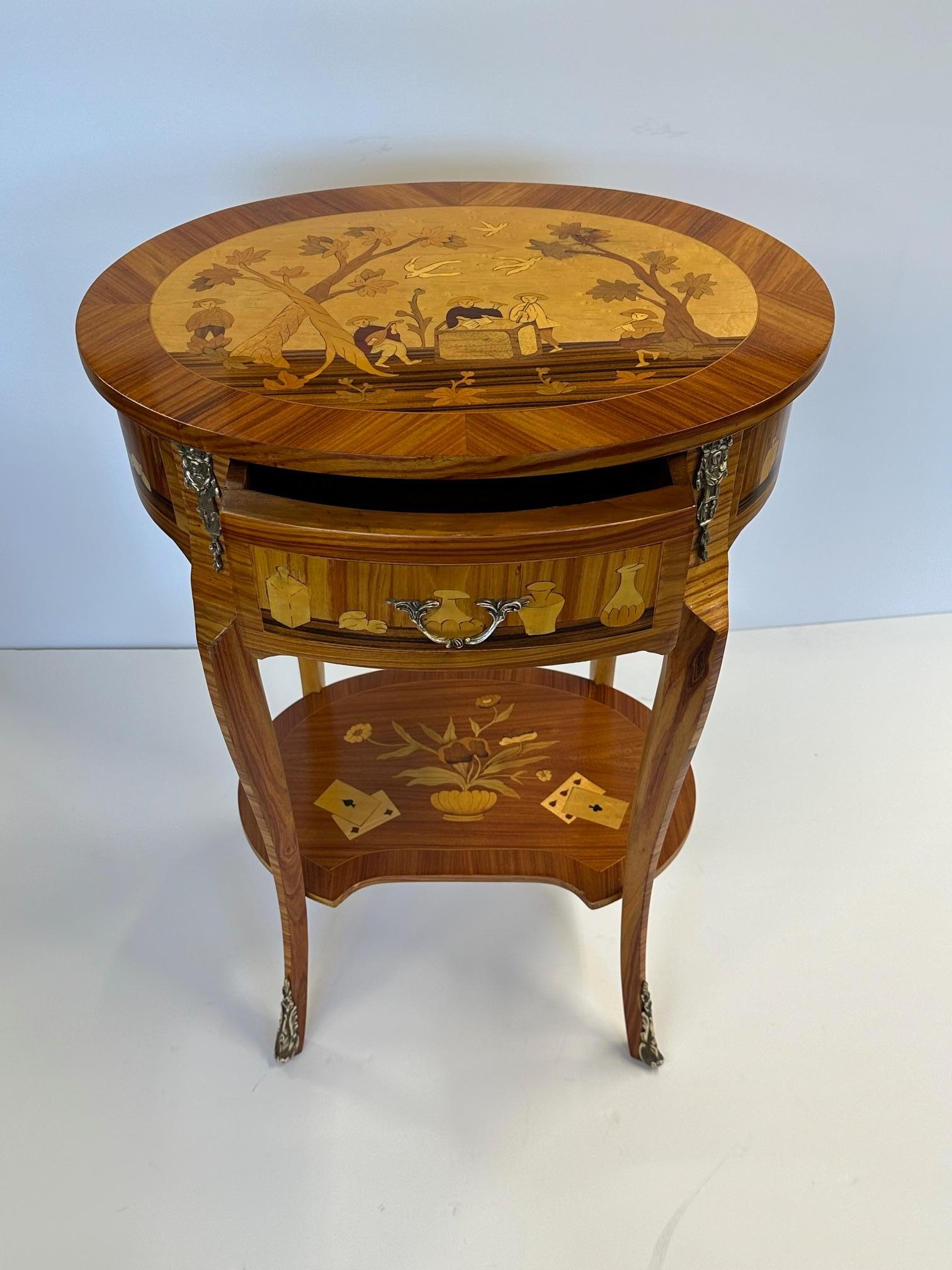 Elegant pair of Italian satinwood and mixed wood inlaid night stands or end tables each having one drawer, second tier with playing card decoration, and sinuous curved legs.