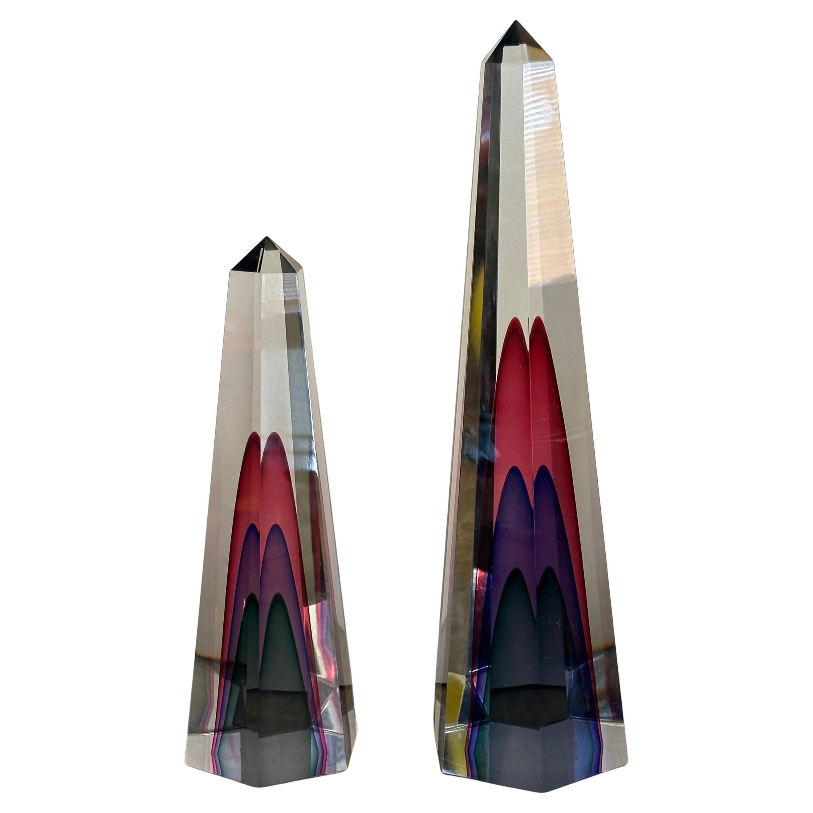 Gorgeous pair of multi sommerso art glass obelisks by Luigi Onesto for Murano Glass, circa 1996.  The pair are in very good vintage condition with one small scratch on the backside of the taller piece - (please see pictures) and measure 5.5