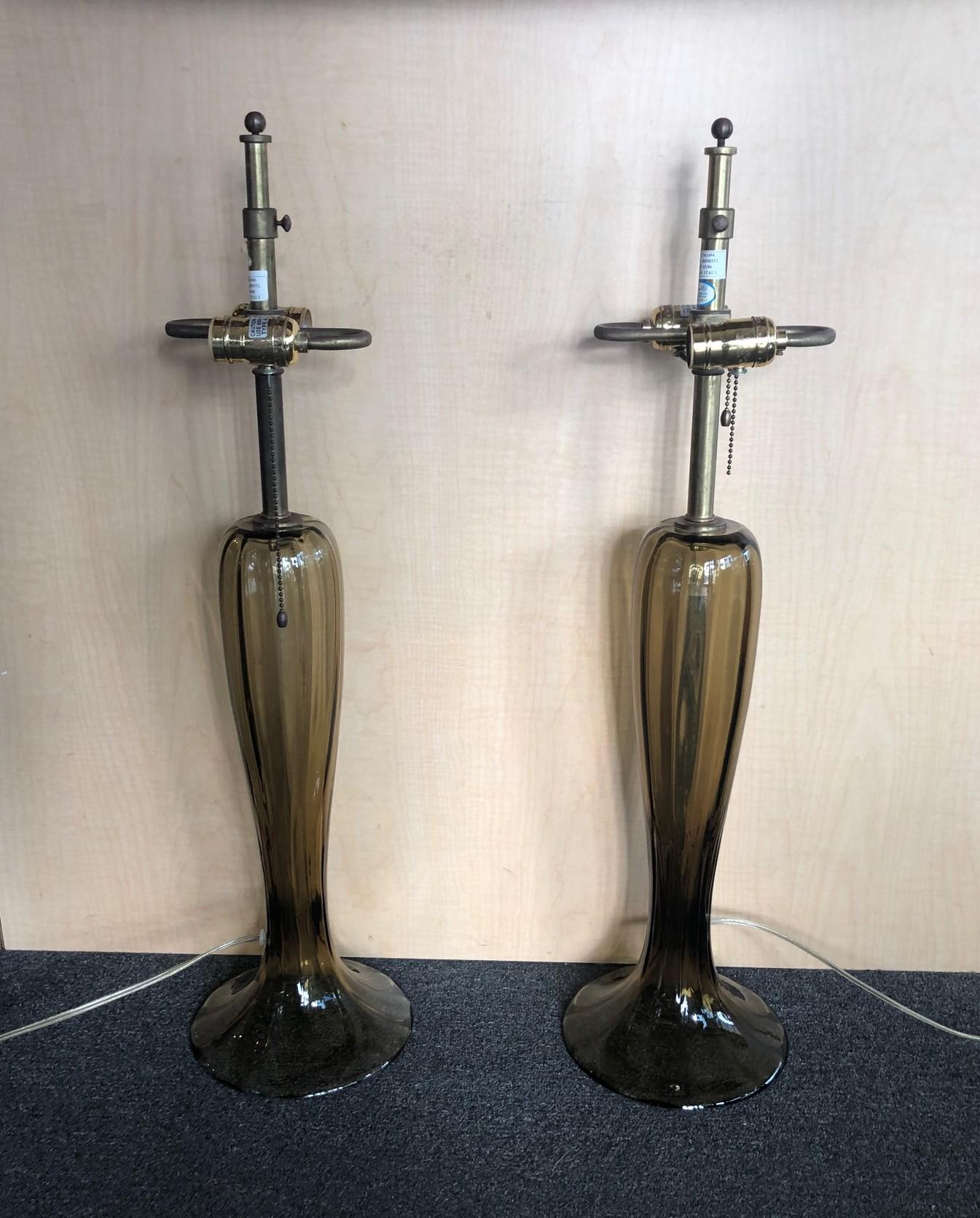A simply gorgeous pair of Murano art glass trumpet lamps in a smoky topaz color. The lamps are quite tall, slender and ribbed lamp with a splayed foot. The height is adjustable from 29