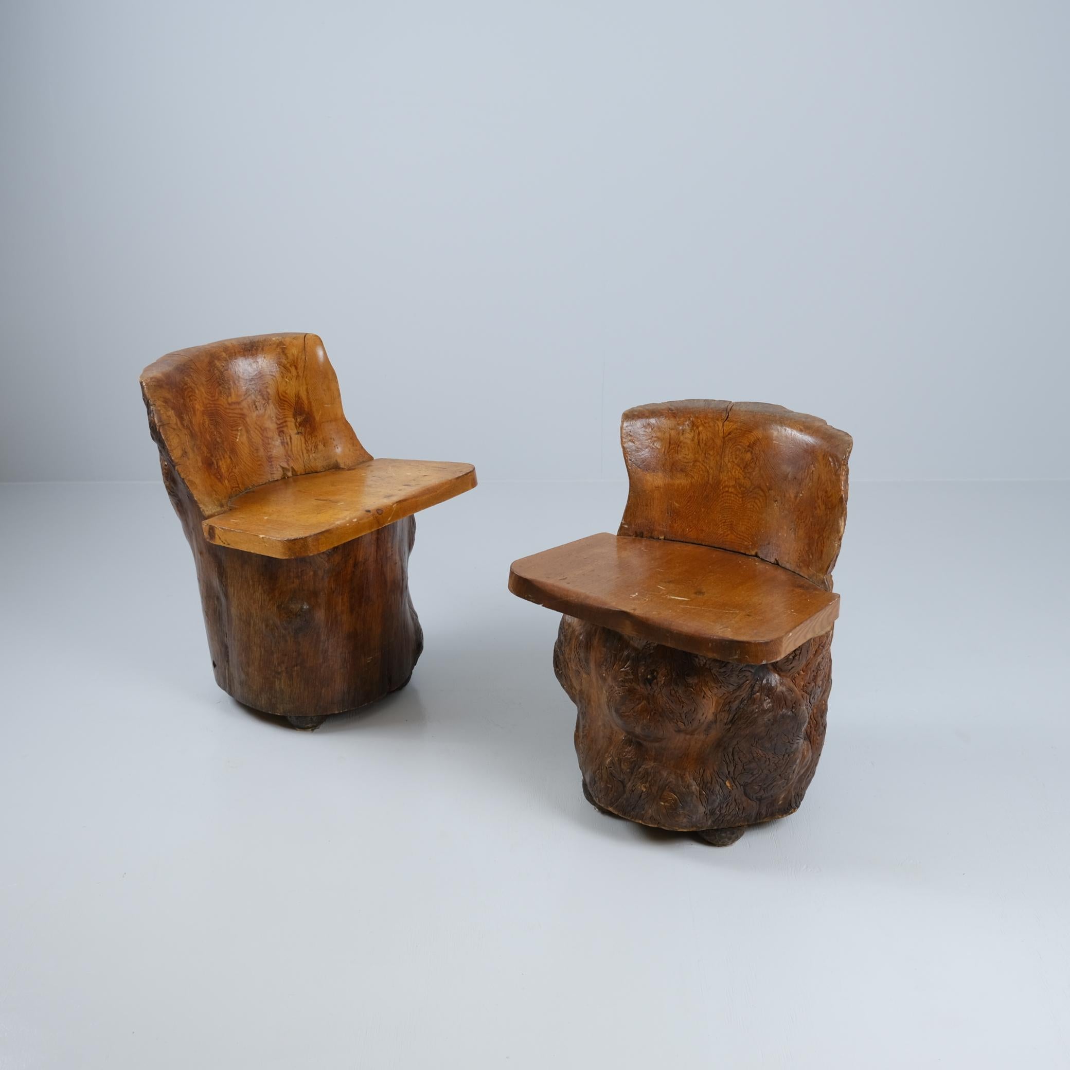 Two chairs carved out of tree trunks. Both chairs are in great condition and very sturdy. The impressive size of the chairs makes the carving work even more respectable, as the chairs are completely hollow and thus light and easy to move around. The