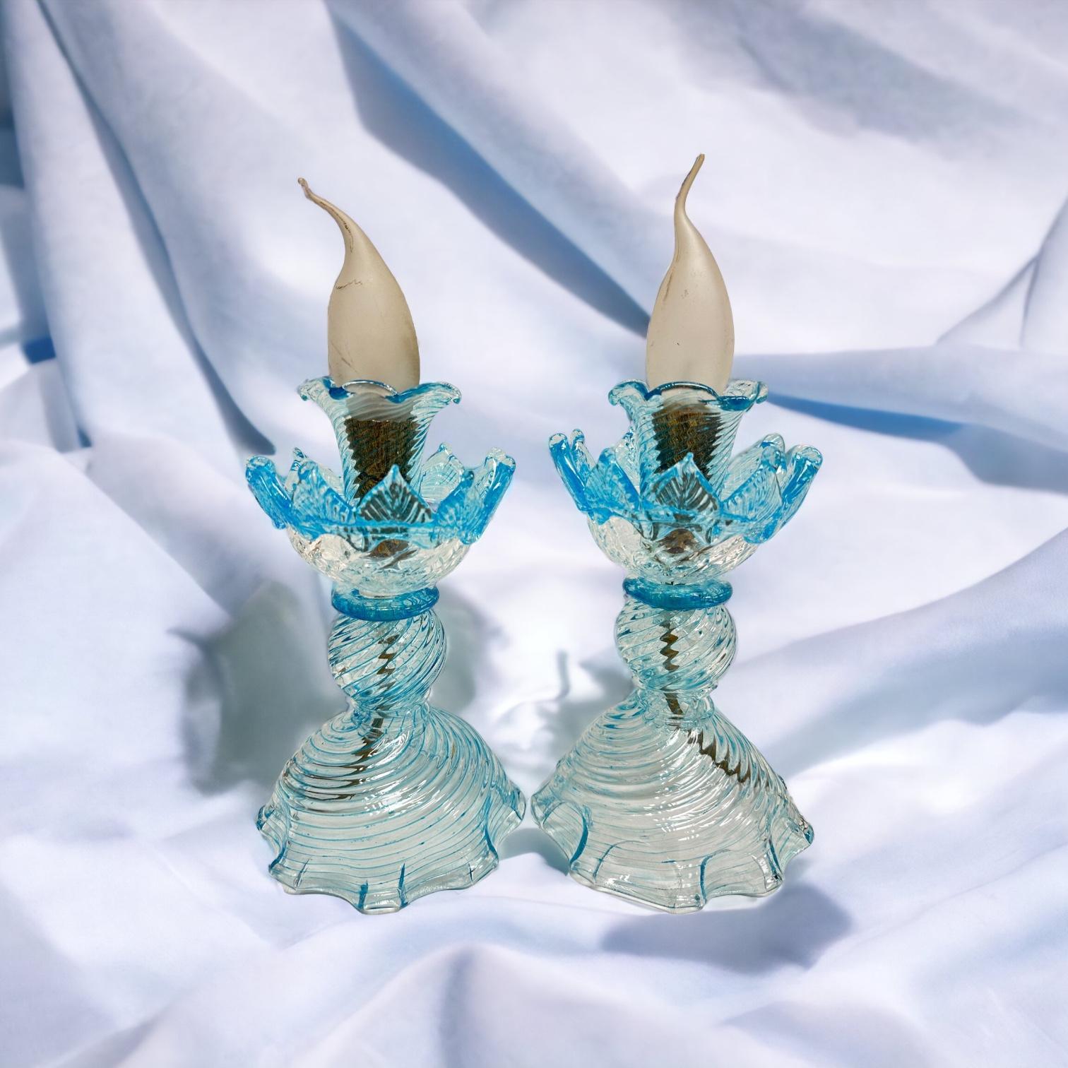 Gorgeous pair of petite table lamps or bedside table lamps. Made of clear Murano glass with light blue edges, made by a Murano glass company in Venice, Italy. Each light requires one European E14 / 110 Volt Candelabra bulb, up to 60 watts. Total