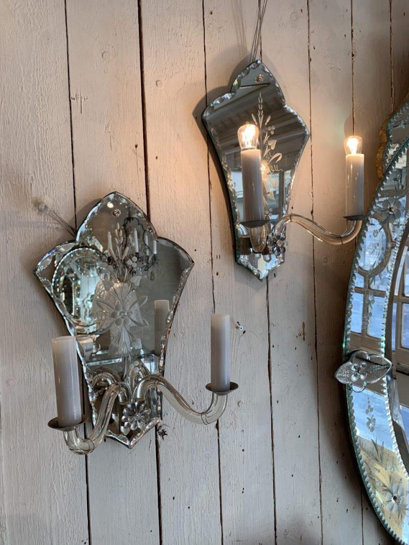 1 lovely pair of wall lamps, in Venetian mirror glass from circa 1930s France. Each sconse has two solid glass arms with a socket for a light bulb, hidden behind beautiful white opaque glass light cuffs. Each wall mount is covered with a beautiful